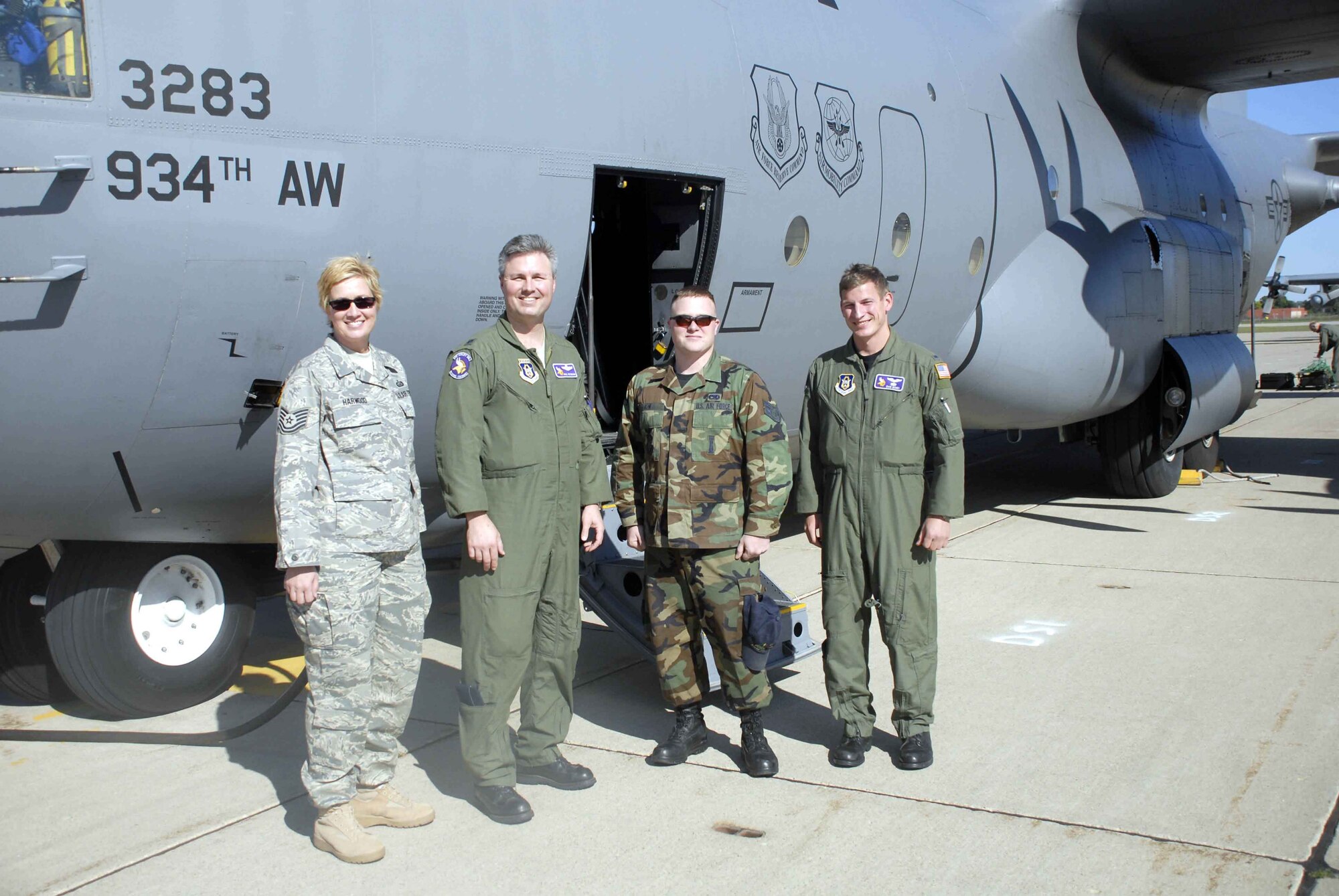 Tech. Sgt. Suzzanne Harwood, (left) 934th Airlift Wing NCO of the Year, and Senior Airman Roger Falnes, (third from left) 934 AW Airman of the Year, received a C-130 incentive ride flown by Lt. Col. Paul Peterson (second from left) pilot, and 2nd Lt. Dan Schei, navigator, 96th Airlift Squadron. (Air Force photo/Master Sgt. Paul Zadach)