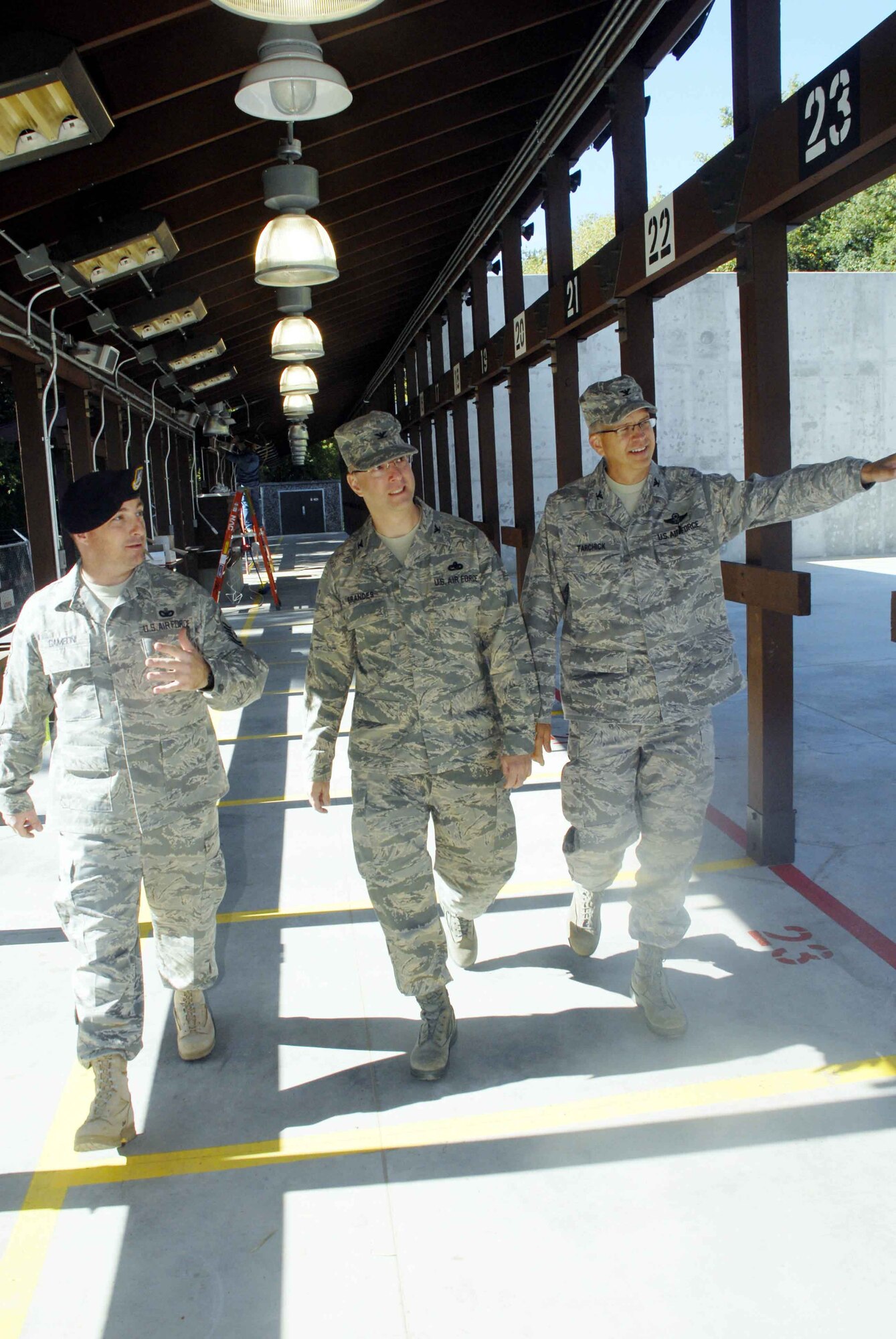 From left, Master Sgt. Tony Gamboni, 934th Security Forces Squadron, gives a tour of the new firing range to Col. Eric Brandes, 934th Maintenance Group commander, and Col. Tim Tarchick, 934th Airlift Wing commander.  The facility is now open and features heated firing stations and steel bullet traps with automated scavenging systems to recover spent ammunition. (Air Force photo/Master Sgt. Paul Zadach
