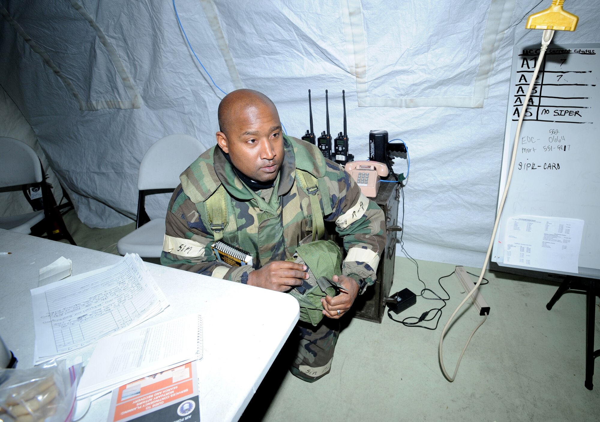 ELMENDORF AIR FORCE BASE, Alaska -- Tech. Sgt. Marc Bailey, 3rd Mission Support Squadron, dons his mask as he prepares to go MOPP 4 after an explosion during the Polar Force 09-1 exercise Oct. 29. The explosion was one of many different scenarios presented to personnel during the three-day exercise. (U.S. Air Force photo/Senior Airman Matthew Owens)