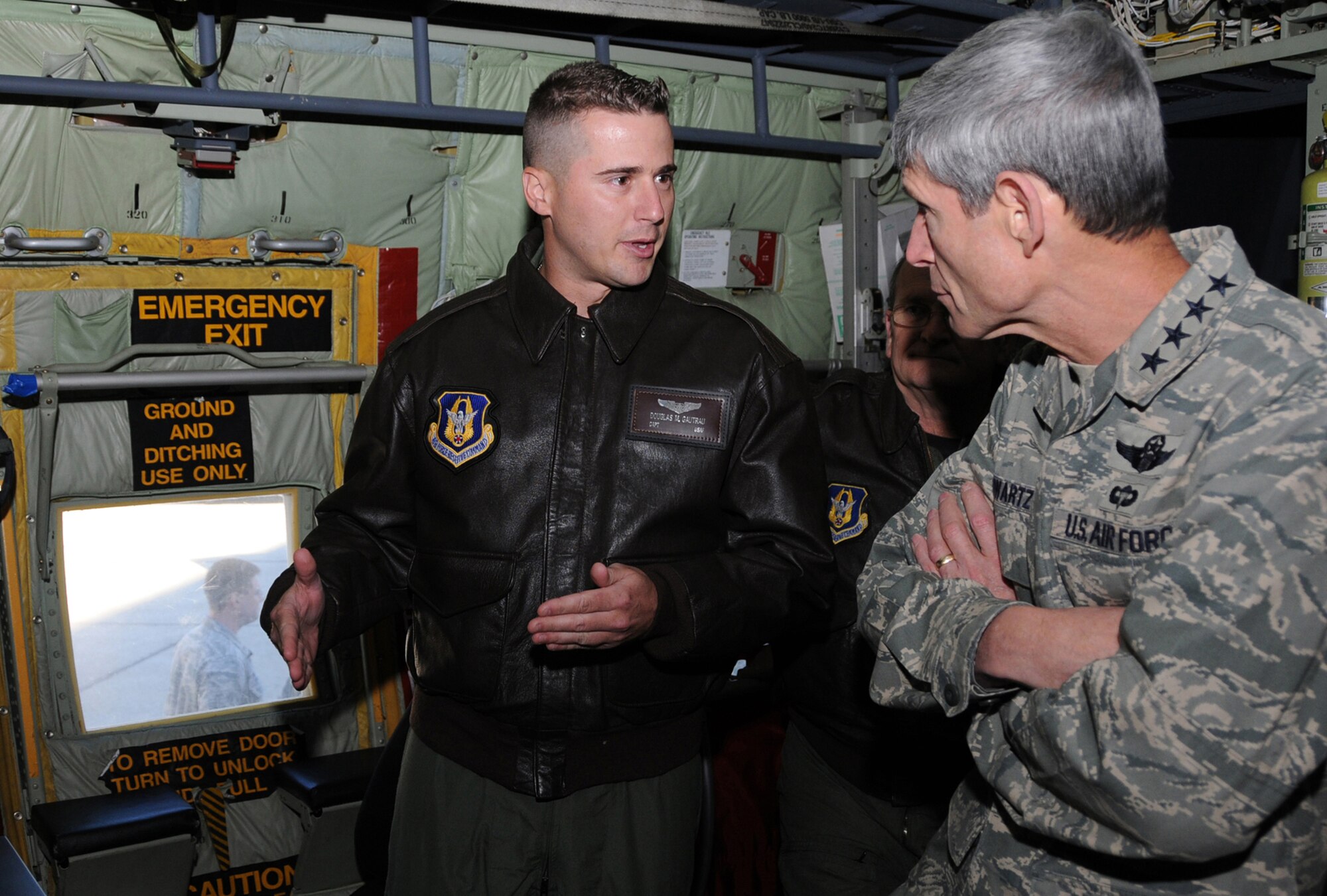 Capt. Douglas Gautrau, 53rd Weather Reconnaissance Squadron, shows General Schwartz the equipment inside a WC-130J aircraft used by the Hurricane Hunters to monitor weather conditions.  (U.S. Air Force photo by Kemberly Groue)