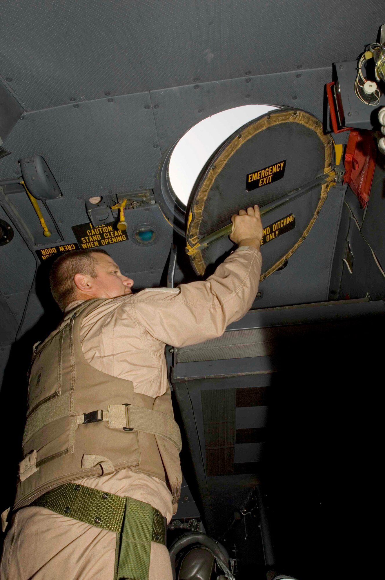 Lt. Col. Jim Nowak, 934th Airlift Wing navigator, opens the escape hatch above the cockpit of a C-130 Hercules to cool the aircraft's interior prior to takeoff from Joint Base Balad, Iraq, Oct. 6.  Colonel Nowak was assigned to the 746th Expeditionary Airlift Squadron while deployed to Southwest Asia. (U.S. Air Force photo/Tech. Sgt. Erik Gudmundson) 

 

