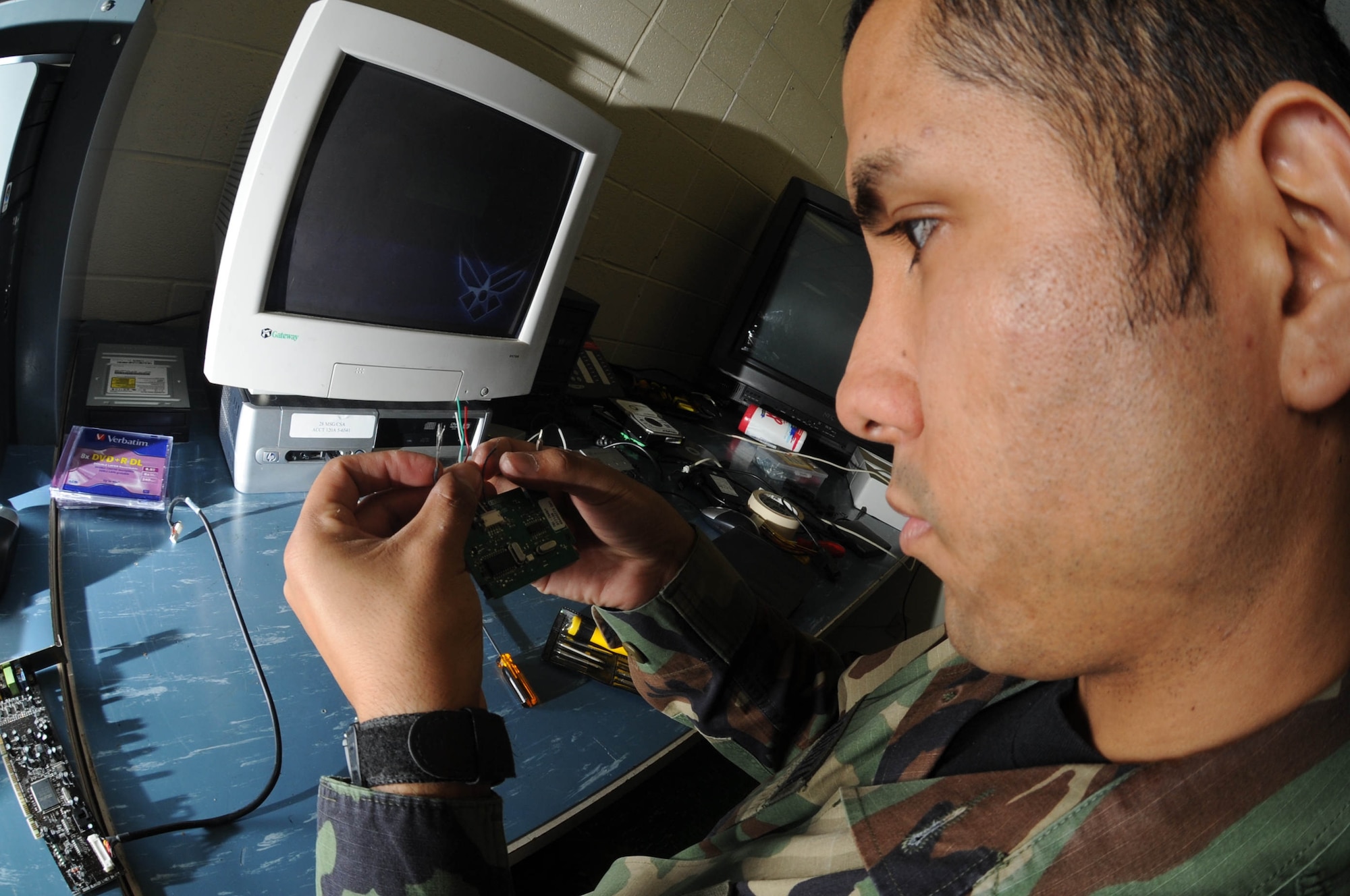 Senior Airman Joshua Ortiz-Mendoza, 28th Mission Support Group client support administrator craftsman, separates the wires of a Common Access Reader here, Oct. 30.  The CAC is used as a general identification card as well as for authentication to enable access to Department of Defense computers, networks. (U.S. Air Force photo/Airman 1st Class Adam Grant)