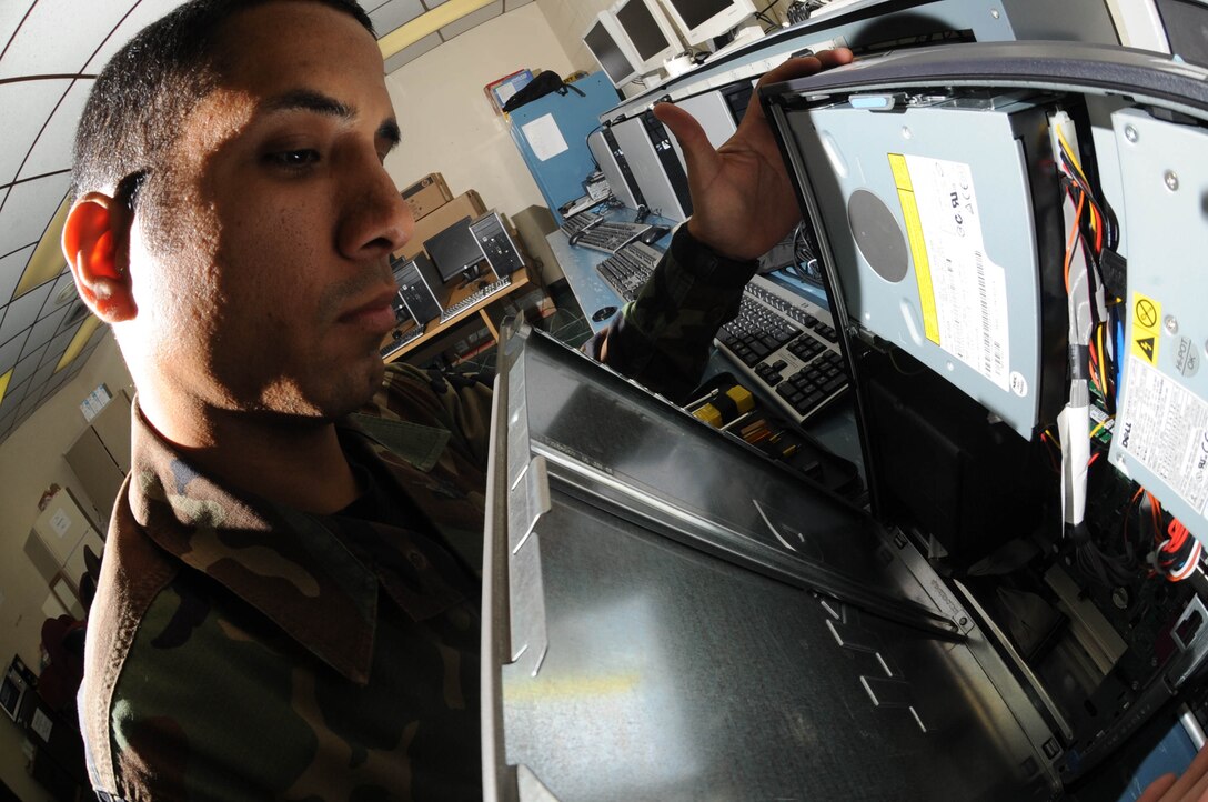 Senior Airman Joshua Ortiz-Mendoza, 28th Mission Support Group client support administrator craftsman, removes the side panel of a computer tower here, Oct.  30. Airmen of the 28 CS provide reliable, efficient and secure communications for rapid, decisive and sustainable combat air power. (U.S. Air Force photo/Airman 1st Class Adam Grant)