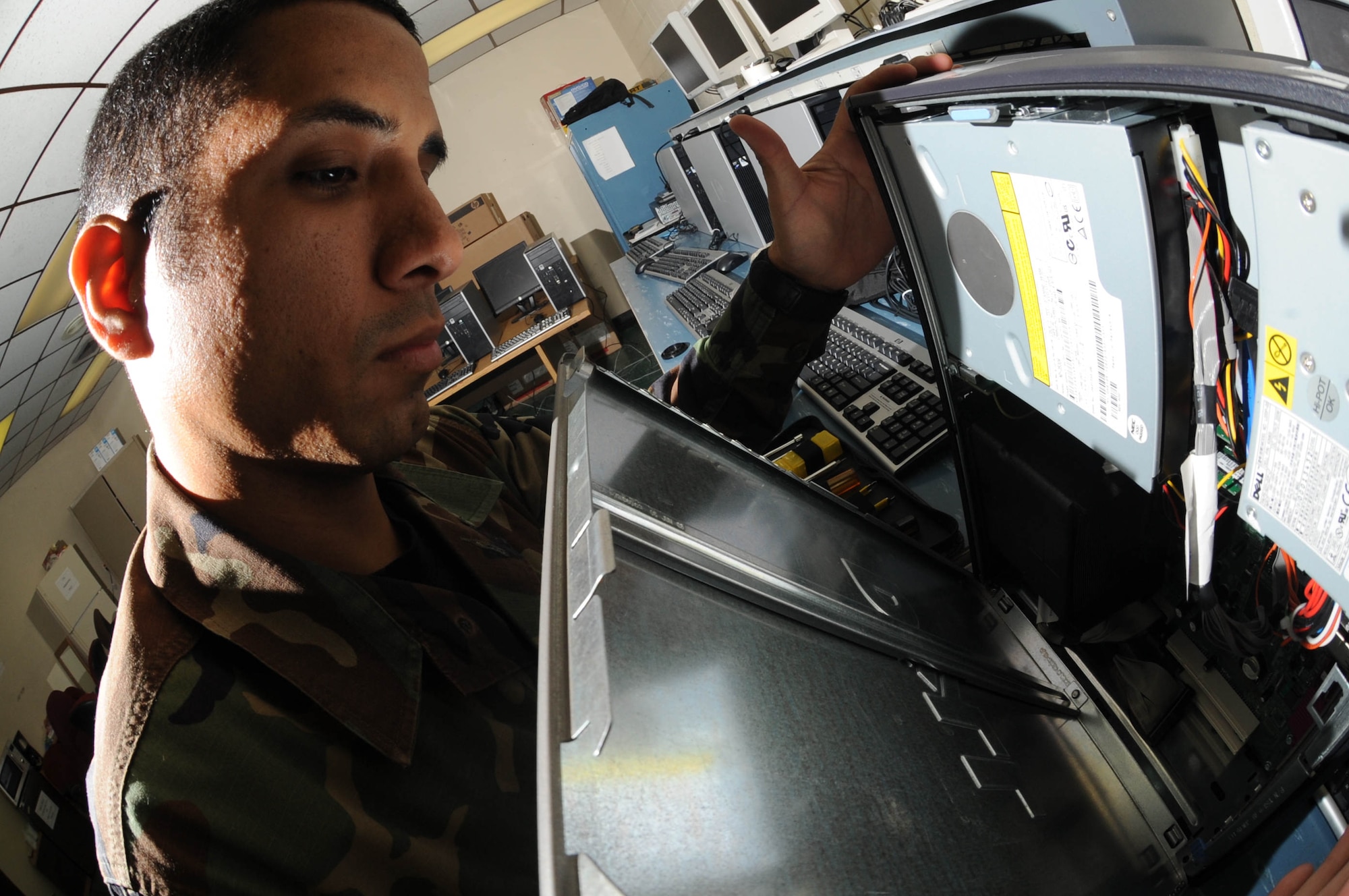 Senior Airman Joshua Ortiz-Mendoza, 28th Mission Support Group client support administrator craftsman, removes the side panel of a computer tower here, Oct.  30. Airmen of the 28 CS provide reliable, efficient and secure communications for rapid, decisive and sustainable combat air power. (U.S. Air Force photo/Airman 1st Class Adam Grant)