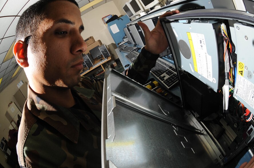 Senior Airman Joshua Ortiz-Mendoza, 28th Mission Support Group client support administrator craftsman, removes the side panel of a computer tower here, Oct.  30. Airmen of the 28 CS provide reliable, efficient and secure communications for rapid, decisive and sustainable combat air power. (U.S. Air Force photo/Airman 1st Class Adam Grant)