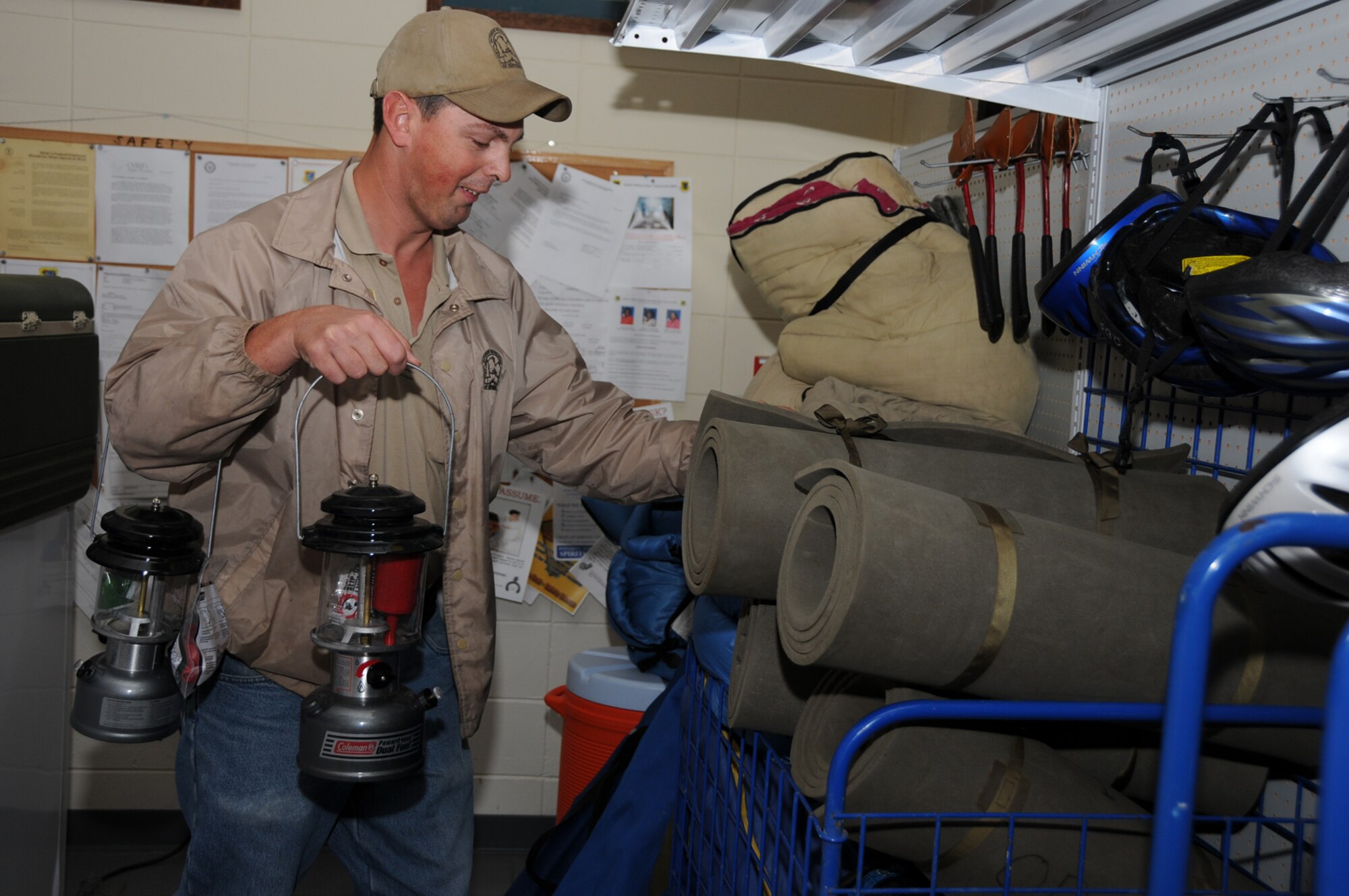 Sean Hoda stores camping gear for rent at the outdoor recreation building at marina park.  (U.S. Air Force photo by Kemberly Groue)