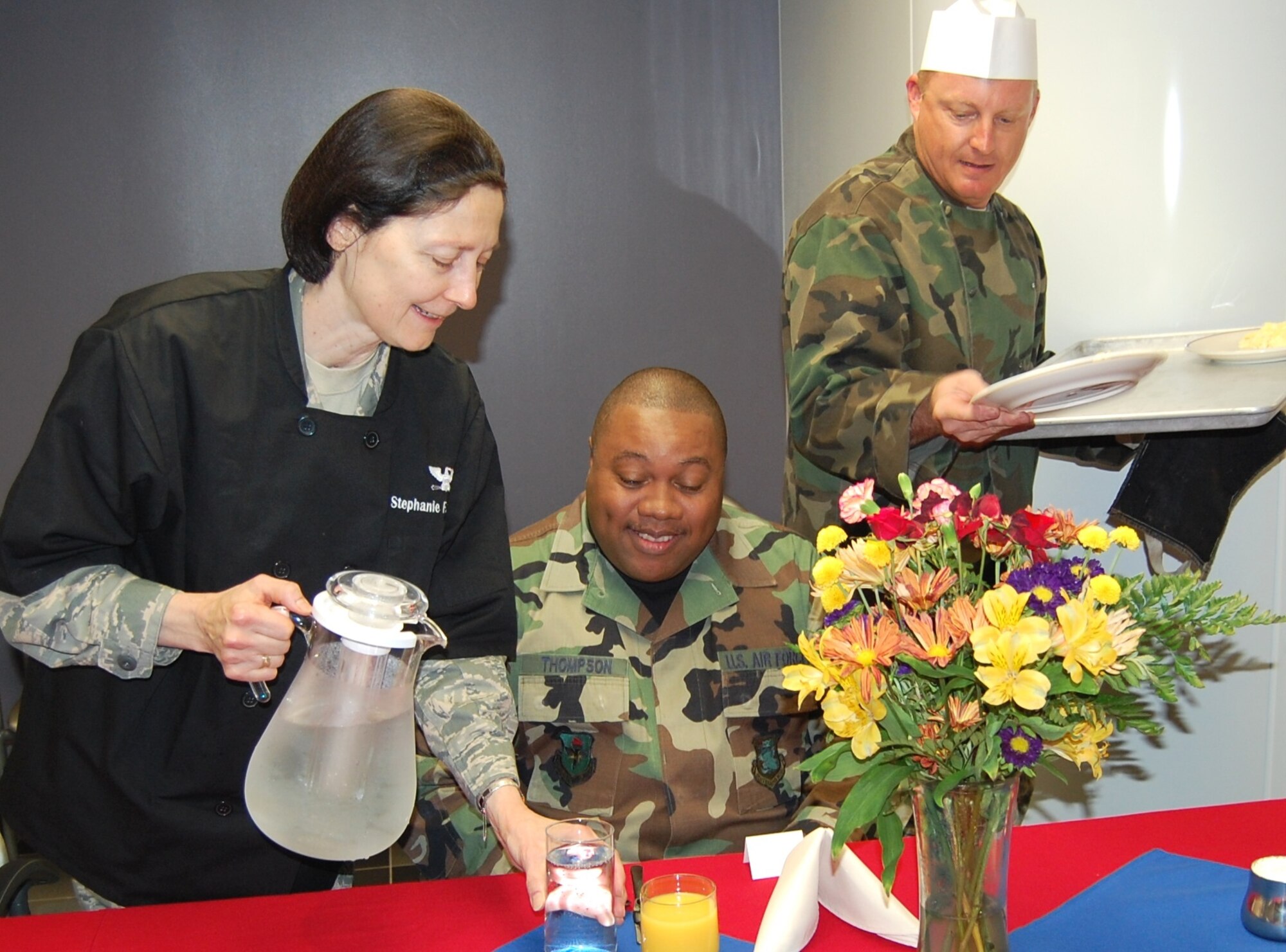 Colonels McCann, left, and Dietz serve Sergeant Thompson breakfast.  (U.S. Air Force photo by Steve Pivnick)
