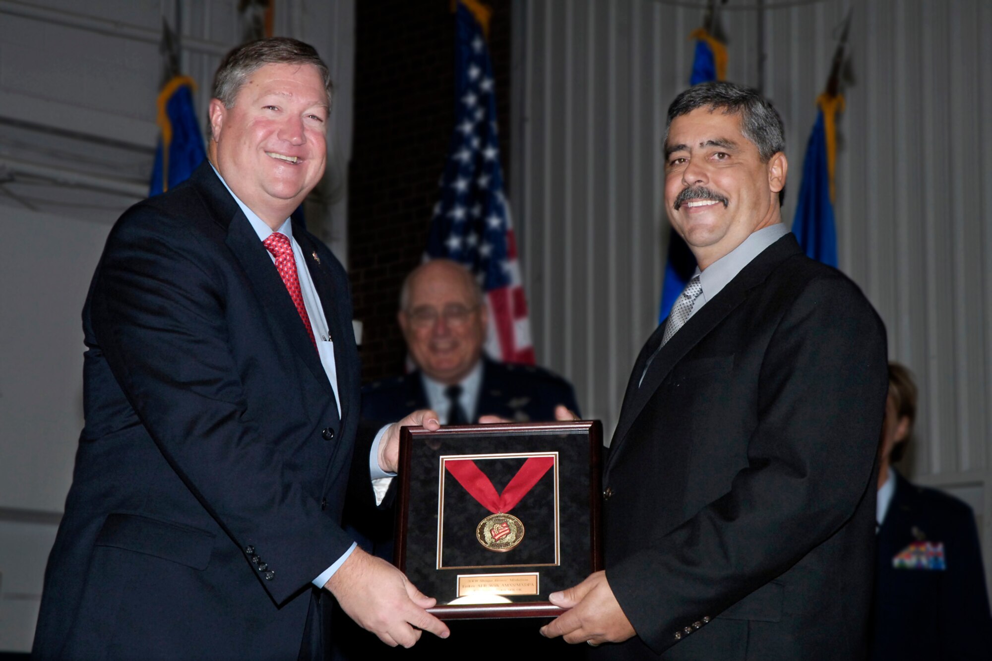 Secretary of the Air Force Michael B. Donley, and B-1 production chief, Melvin Goodwin, hold the Shingo Prize Bronze Medal awarded to the programmed depot maintenance line at the Oklahoma City Air Logistics Center. The award has been called the “Nobel Prize of manufacturing.” Secretary Donley praised the center’s efforts to streamline their operations, getting materiel to the warfighter more efficiently and saving taxpayers’ money. “It really reflects very well on your commitment to excellence in everything you do, and a commitment to continuous improvement on leaning-out these lines,” Secretary Donley said. Secretary Donley visited Tinker for the ceremony celebrating the partnership between the Air Force and the community that brought about the new Tinker Aerospace Complex. (Air Force photo/Margo Wright)