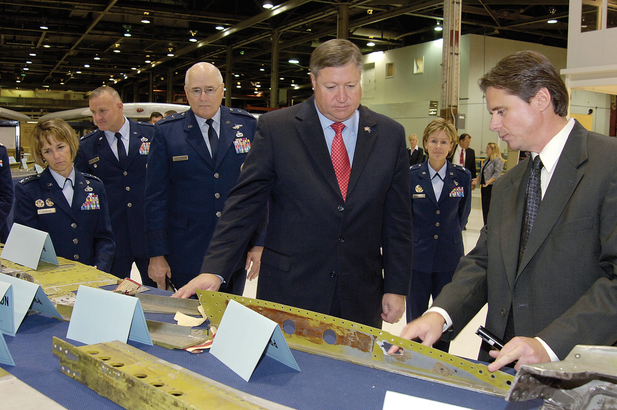 From left, Lt. Gen. Terry Gabreski, vice commander of Air Force Materiel Command; Col. David Funk, headquarters AFMC; Maj. Gen. Loren Reno, Oklahoma City Air Logistics Center Commander; Secretary of the Air Force, Michael B. Donley; and 76th Maintenance Wing commander, Brig. Gen. Judith Fedder; listen as Steve Stoner, 564th Aircraft Maintenance Squadron briefs a display of KC-135 parts during a tour of the Air Logistics Center, where workers perform programmed depot-level maintenance on aircraft. (Air Force photo/Margo Wright)