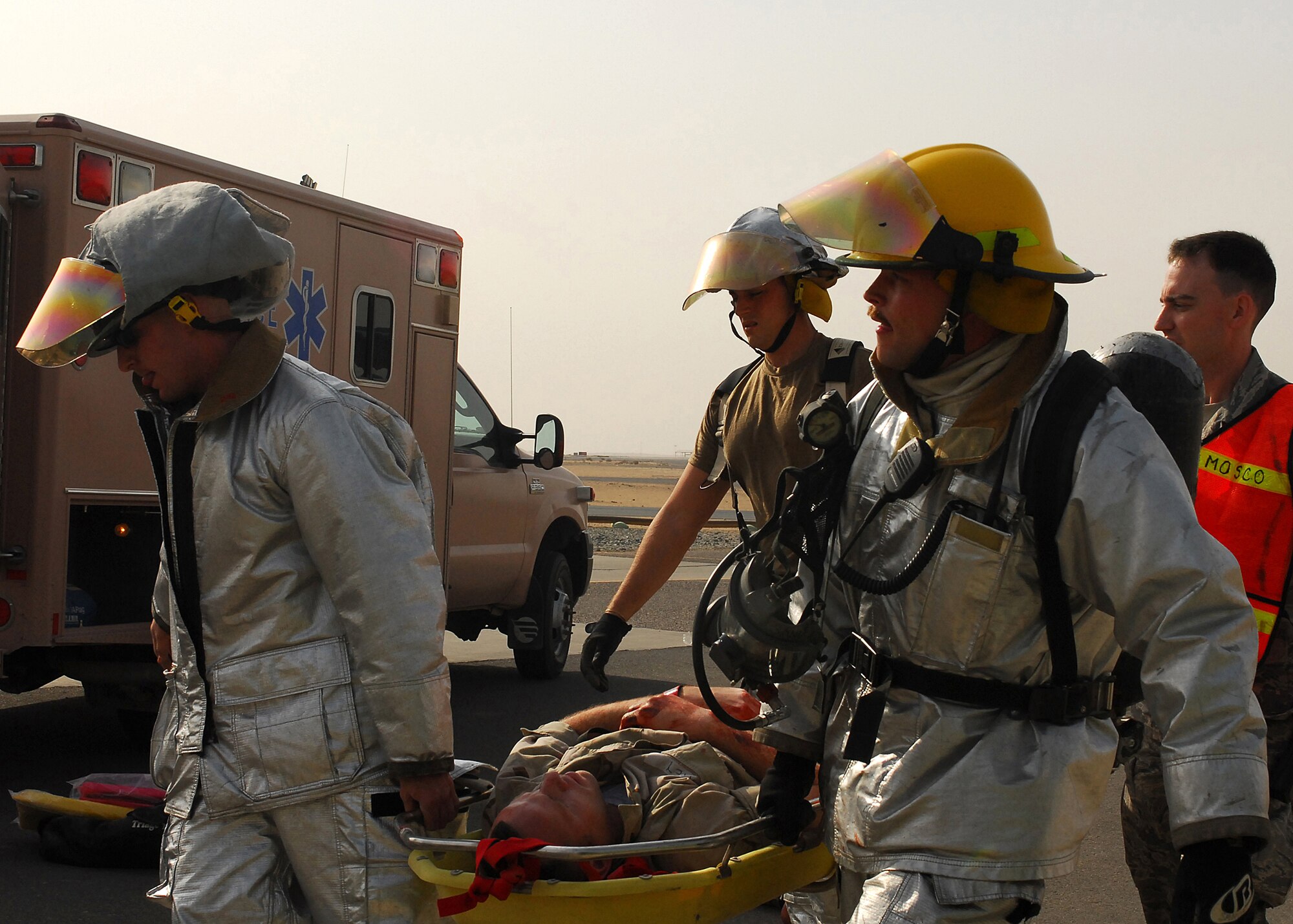 SOUTHWEST ASIA -- Firefighters and medical personnel from the 386th Air Expeditionary Wing transport a patient to an ambulance during a mass casualty exercise on Oct. 29 at an air base in Southwest Asia. The exercise tested the 386th Air Expeditionary Wing's ability to respond to a major accident in a deployed environment. (U.S. Air Force photo/Airman 1st Class Nicole Brosseau)