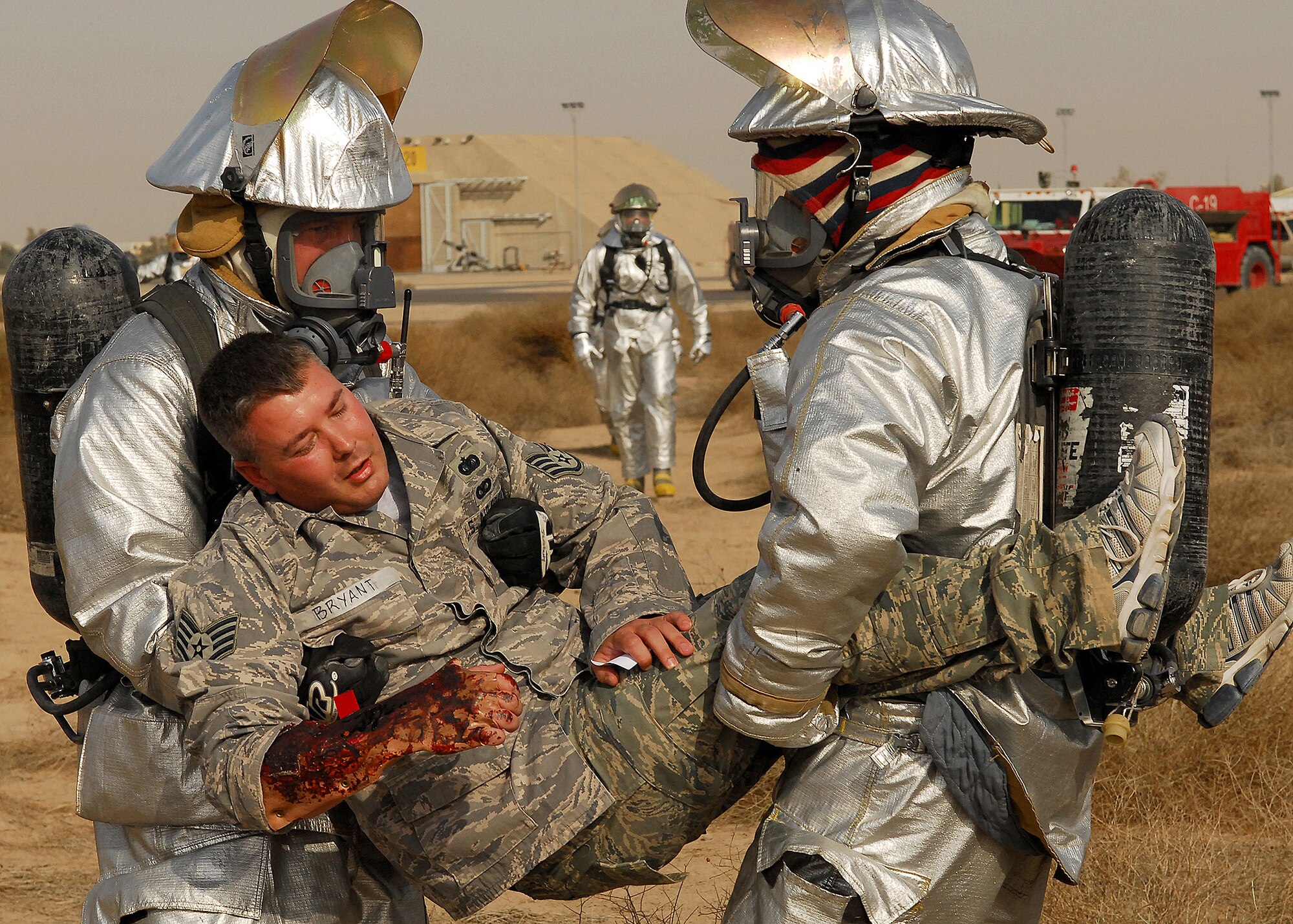 SOUTHWEST ASIA -- Firefighters from the 386th Expeditionary Civil Engineering Squadron transport a patient during a mass casualty exercise on Oct. 29 at an air base in Southwest Asia. The exercise tested the 386th Air Expeditionary Wing's ability to respond to a major accident in a deployed environment. (U.S. Air Force photo/Airman 1st Class Nicole Brosseau)