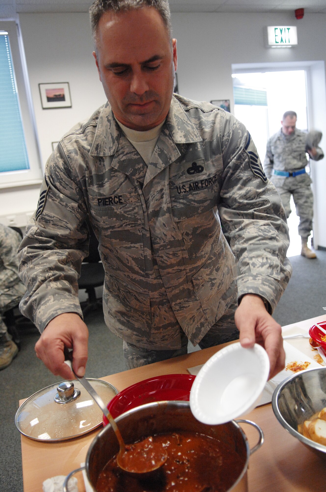SPANGDAHLEM AIR BASE, Germany – Master Sgt. Jonathan Pierce, 52nd Equipment Maintenance Squadron, serves himself a bowl of chili to judge during the 52nd EMS Second Annual Chili Cook-off, Oct. 30.  Six EMS members entered their chili to win bragging rights for the tastiest chili as well as a gold medal.  The event kicked off last year to promote morale; benefits from the event help fund their unit Christmas party. (U.S. Air Force photo by Staff Sgt. Kristin Ruleau)