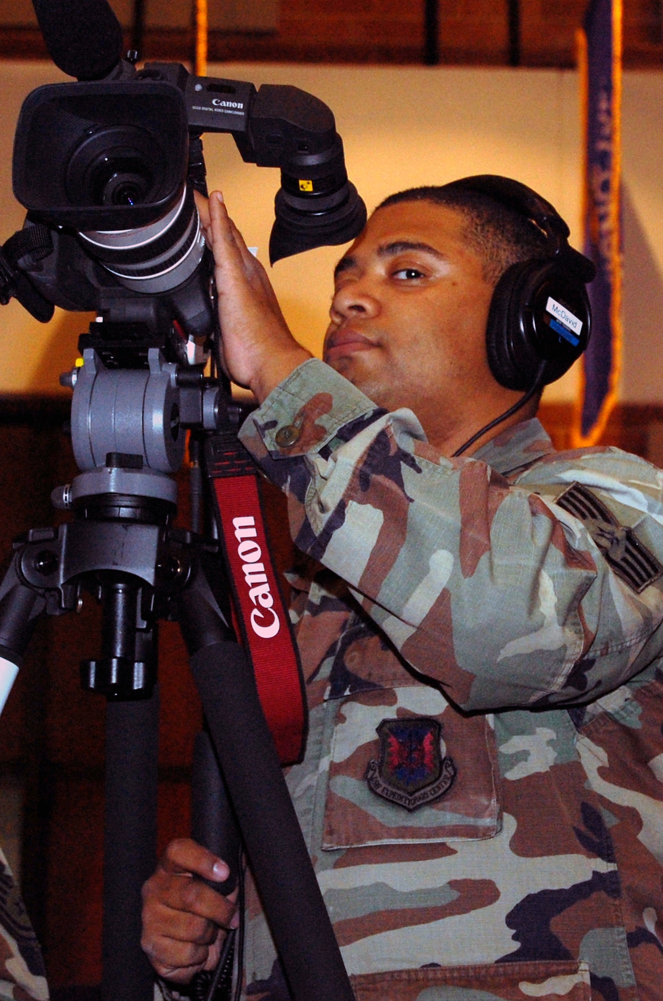 Staff Sgt. Veuril McDavid, videographer for the U.S. Air Force Expeditionary Center on Fort Dix, N.J., covers an event in the center's Grace Peterson Hall Oct. 29, 2008.  Sergeant McDavid is one of three videographers working inside the center who go out and document and support the center's expeditionary training needs.  (U.S. Air Force Photo/Tech. Sgt. Scott T. Sturkol)