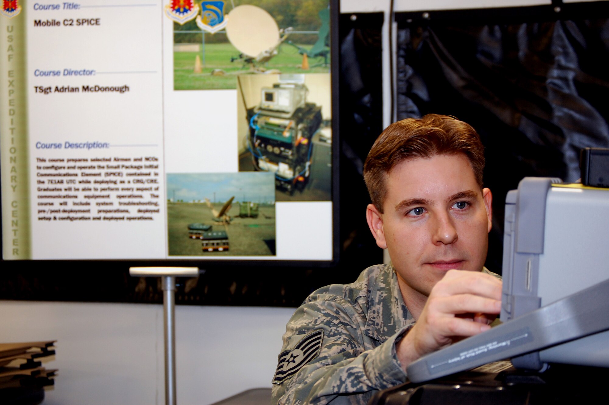 Tech. Sgt. Adrian McDonough, course director for the U.S. Air Force Expeditionary Center's Small Package Initial Communications Element, or SPICE, Course, prepares equipment in a SPICE package for use in the Mobility Operations School's mobile command, control and communications training facility on the Expeditionary Center campus Oct. 29, 2008, on Fort Dix, N.J.  The SPICE Course is a new course in the MOS starting in February 2009.  (U.S. Air Force Photo/Tech. Sgt. Scott T. Sturkol) 