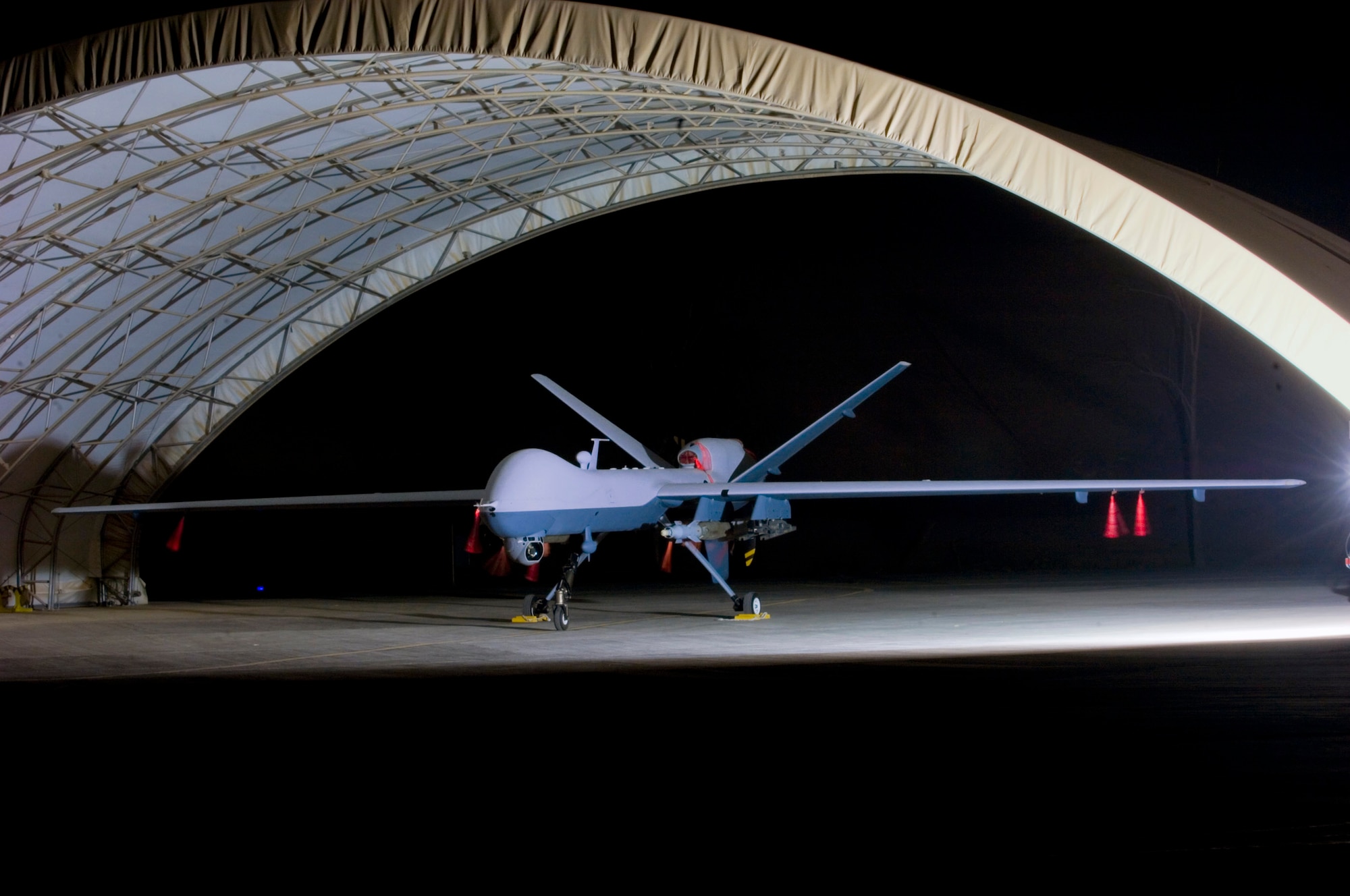 An armed MQ-9 Reaper unmanned aircraft sits in a shelter Oct. 15 at Joint Base Balad, Iraq, before a mission. Larger and more powerful than the MQ-1 Predator, the Reaper can carry up to 3,750 pounds of laser-guided bombs and Hellfire missiles. (U.S. Air Force photo/Tech. Sgt. Erik Gudmundson) 
