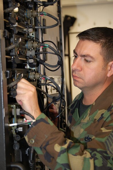 Tech. Sgt. Don Colbert, course director for the U.S. Air Force Expeditionary Center's Mobile Command, Control and Communications Systems Course, works on radio equipment inside the Hard-sided Expandable Lightweight Air Mobile Shelter, or HELAMS, in the Mobility Operations School's Mobile C3 training facility on Fort Dix, N.J., Oct. 29, 2008.  The HELAMS is the Air Force's newest shelter being fielded to contingency response forces to serve as mobile command posts in a bare-base environment.  (U.S. Air Force Photo/Tech. Sgt. Scott T. Sturkol)