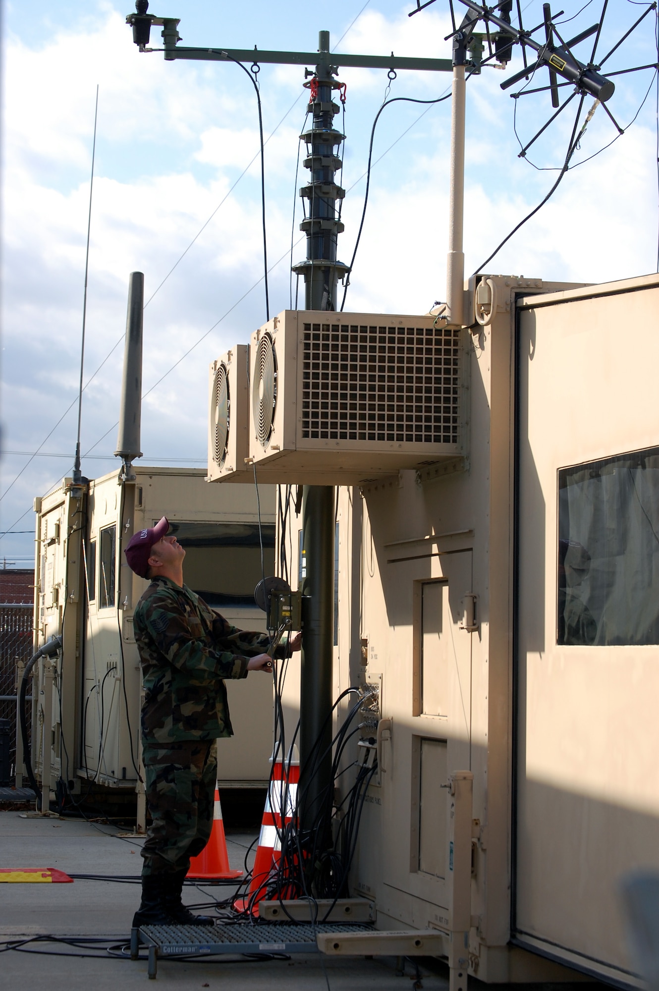 Tech. Sgt. Don Colbert, course director for the U.S. Air Force Expeditionary Center's Mobile Command, Control and Communications Systems Course, works on adjusting an antenna on the Hard-sided Expandable Lightweight Air Mobile Shelter, or HELAMS, in the Mobility Operations School's Mobile C3 training facility on Fort Dix, N.J., Oct. 29, 2008.  The HELAMS is the Air Force's newest shelter being fielded to contingency response forces to serve as mobile command posts in a bare-base environment.  (U.S. Air Force Photo/Tech. Sgt. Scott T. Sturkol)