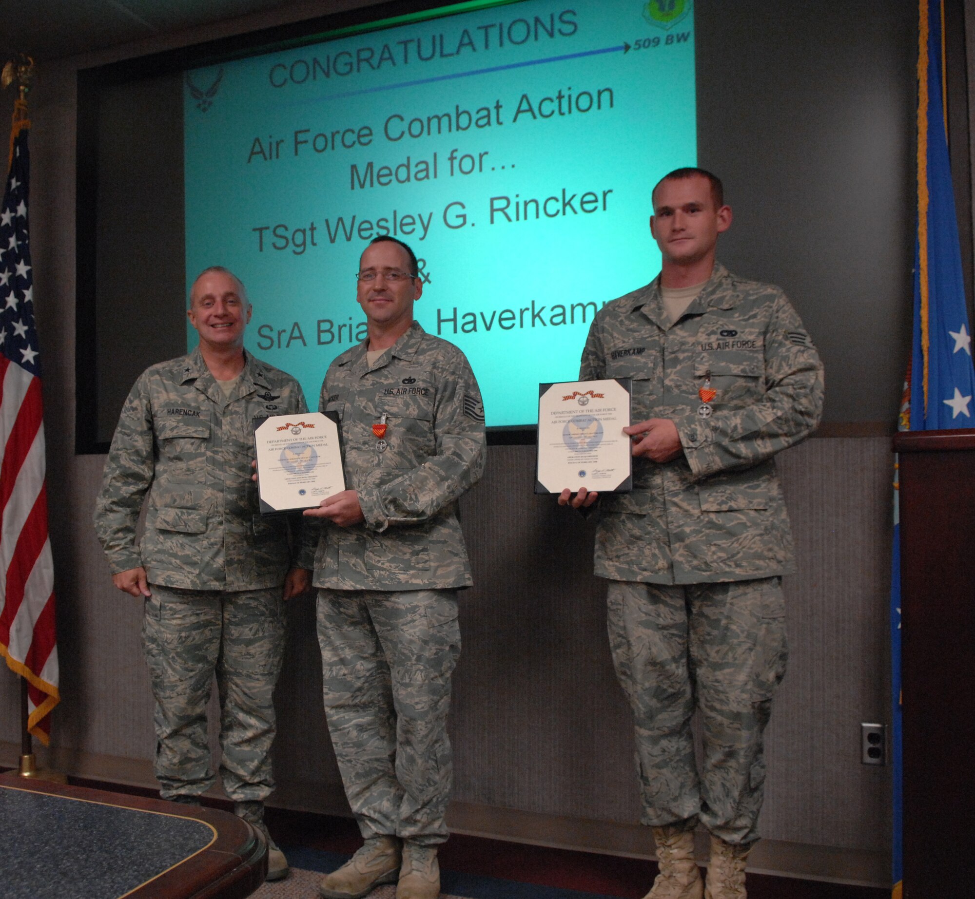 WHITEMAN AIR FORCE BASE, Mo. – Tech. Sgt. Wesley Rincker and Senior Airman Brain Haverkamp, 509th Logistics Readiness Squadron, receive Air Force Combat Action medals Oct. 15 from Brig. Gen. Garrett Harencak, 509th Bomb Wing commander. They each received their medal for actions while deployed to the 70th Medium Truck Detachment. (U.S. Air Force photo/Senior Airman Stephen Linch)