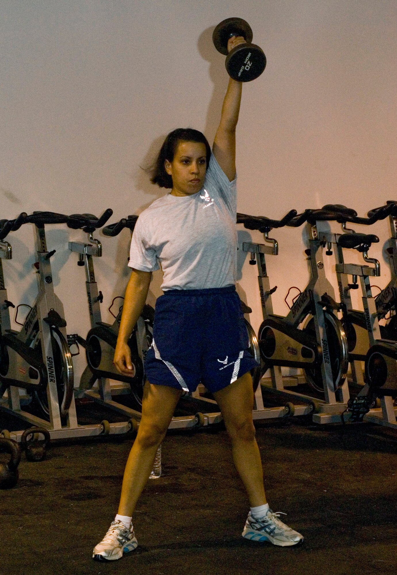 Staff Sgt. Monica France lifts a dumbbell above her head as part of a CrossFit workout in the Red Tail Fitness Center at Joint Base Balad, Iraq, Oct. 30. Faced with a possible medical discharge from the Air Force, France discovered the program, which not only saved her career but improved her overall health. When not working as a personnel journeyman at the 332nd Expeditionary Security Forces Group, France teaches these fitness classes to servicemembers. France is a native of Brooklyn, N.Y., deployed from the 820th Security Forces Group at Moody Air Force Base, Ga. (U.S. Air Force photo/Tech. Sgt. Erik Gudmundson)