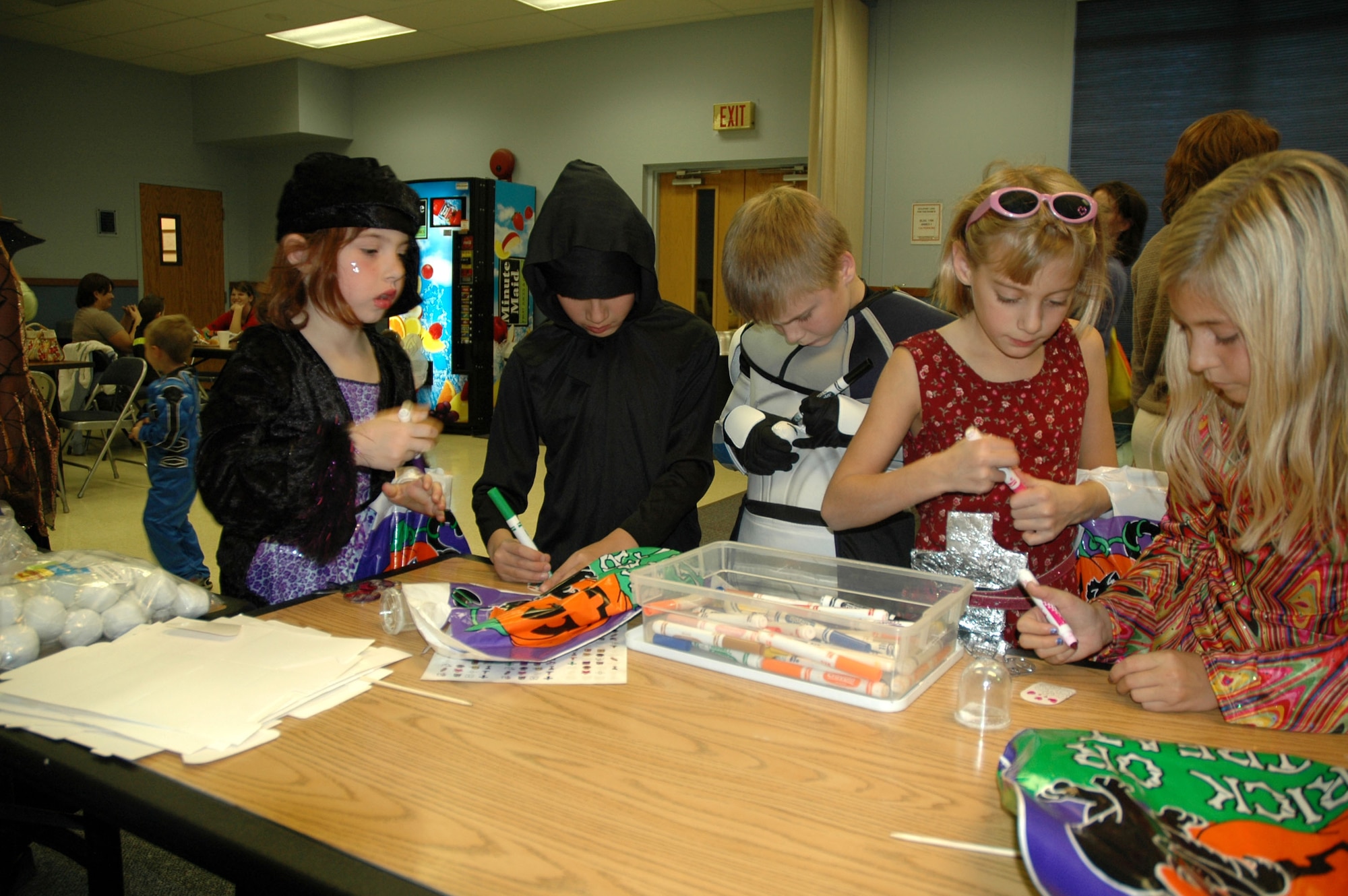 Little Warriors make snow globes during the Harvest Festival Oct. 27 at the base chapel annex. Children also had the opportunity to make tambourines, Thanksgiving wreaths and bracelets, and played games to win prizes. (U.S. Air Force photo/Airman 1st Class Dillon White)