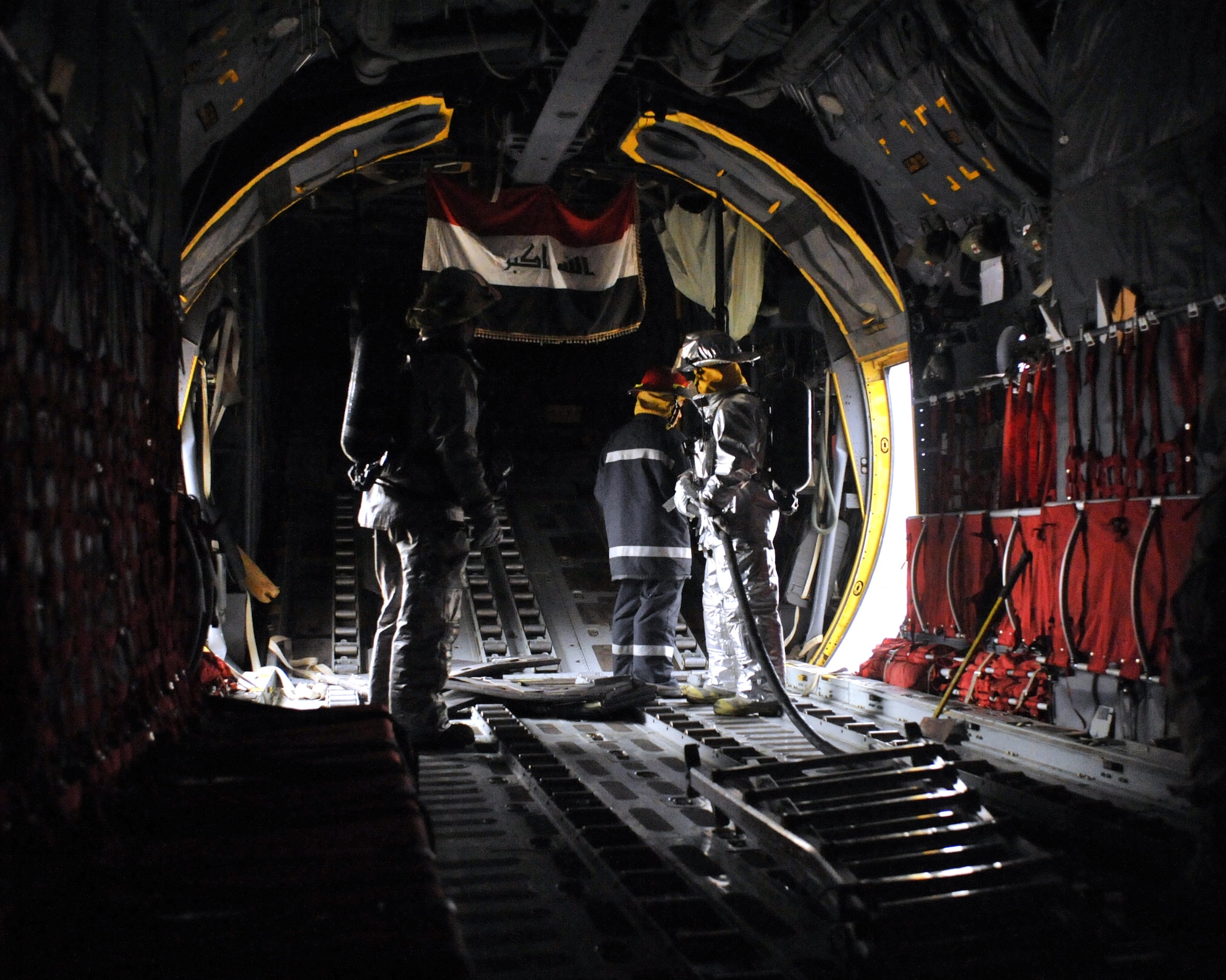 10/29/2008 ? NEW AL MUTHANA AIR BASE, Iraq - U.S. and Iraqi Air Force firefighters train together to learn how to handle a fire in the cargo hold of an Iraqi C-130 Herculese transport aircraft.  (U.S. Air Force photo by Master Sgt. Brian Davidson) 