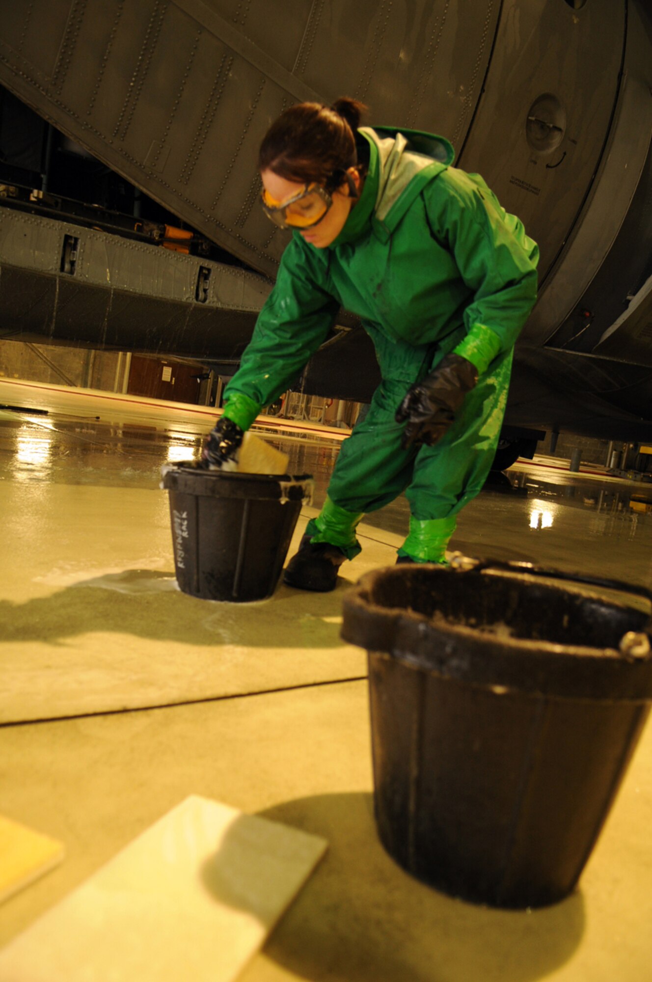 Airman 1st Class Stephanie Hall, 86th Aircraft Maintenance Squadron crew chief, soaps up a sponge to wash the tail end of a C-130E Hercules aircraft in Hangar 1, Ramstein Air Base, Germany, Oct. 28, 2008. The wash crew is made up of a 12-member team from the 86th AMXS who wash aircraft every 90 days to keep them mission ready. (U.S. Air Force photo by Airman 1st Class Scott Saldukas)