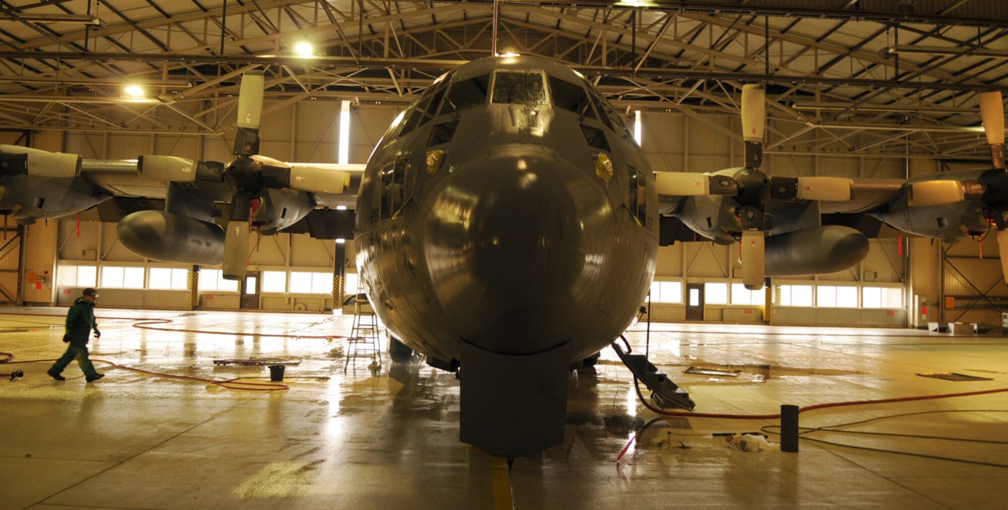 Members from the 86th Aircraft Maintenance Squadron prepare to wash a C-130E Hercules in Hangar 1, Ramstein Air Base, Germany, Oct. 28, 2008. The wash crew is made up of a 12-member team from the 86th AMXS who wash aircraft every 90 days to keep them mission ready. (U.S. Air Force photo by Airman 1st Class Scott Saldukas)