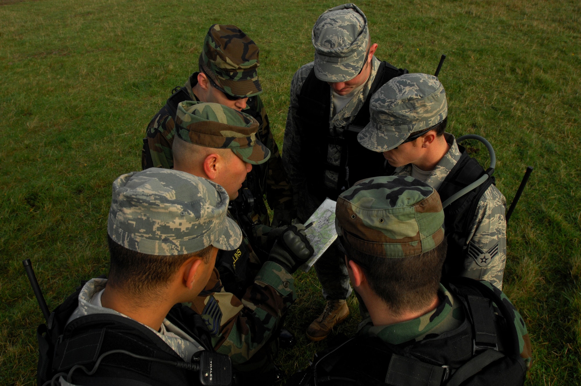 Tech. Sgt. Somchai Rollins (center), 786th Security Forces Squadron, Creek Defender instructor, explains a convoy training route to new cadres during a week-long instructor?s course, Baumholder, Germany, Oct. 23, 2008. (U.S. Air Force photo Airman 1st Class Kenny Holston)