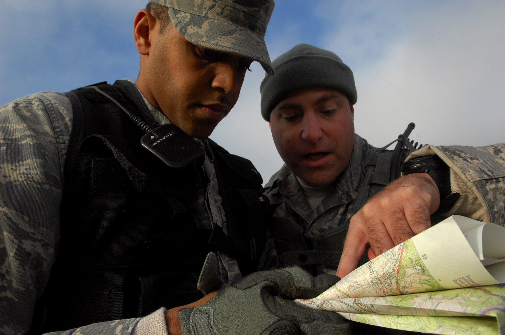 Tech. Sgt. James Slavens (right), 786th Security Forces Squadron Creek Defender instructor, explains logistics of training maps and each training zone to Senior Airman Rodney Gattis, 786th Security Forces Squadron, during a week-long Creek Defender cadre instructor's course, Baumholder, Germany, Oct. 23, 2008. (U.S. Air Force photo Airman 1st Class Kenny Holston)