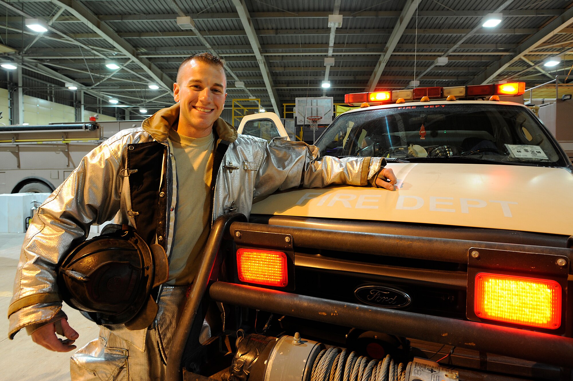 Senior Airman Derek Larson is the 332nd Air Expeditionary Wing's Tuskegee Airman of the Week for Oct. 13-19. Larson, shown here next to his rescue vehicle in the fire station at Joint Base Balad, Iraq, Oct. 29, recently saved the lives of two Iraqis with gunshot wounds at the East Entry Control Point. Larson, a fire protection driver-operator with the 332nd Expeditionary Civil Engineer Squadron, is deployed from Dover Air Force Base, Del. His hometown is Omaha, Neb. (U.S. Air Force photo/Airman 1st Class Jason Epley)(Released)