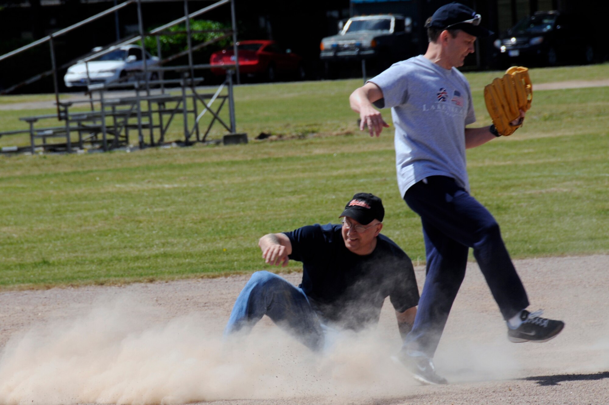 Chief Master Sgt. Jeffrey Williams, 48th Fighter Wing command chief, slides safely into second base during a Chiefs and Eagles softball game at RAF Lakenheath, England. Chief Williams was ruled safe, much to the chagrin of Brig. Gen. Jon Hesterman. (U.S. Air Force photo by Airman 1st Class Perry Aston)