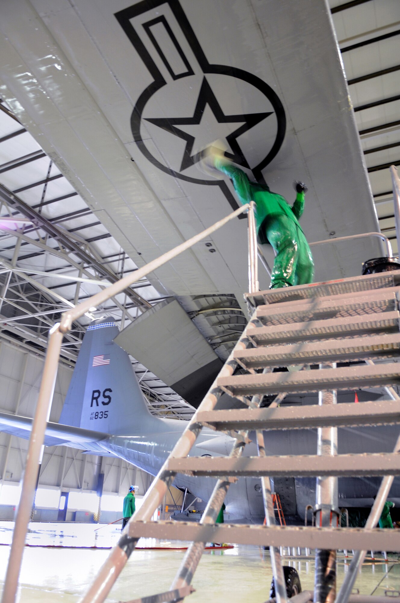 Staff Sgt. Darren Garger, 86th Aircraft Maintenance Squadron crew chief, scrubs a C-130E Hercules in Hanger 1, Ramstein Air Base, Germany, Oct. 28, 2008. The wash crew is made up of a 12-member team from the 86th AMXS who wash aircraft every 90 days to keep them mission ready. (U.S. Air Force photo by Airman Alexandria Mosness)