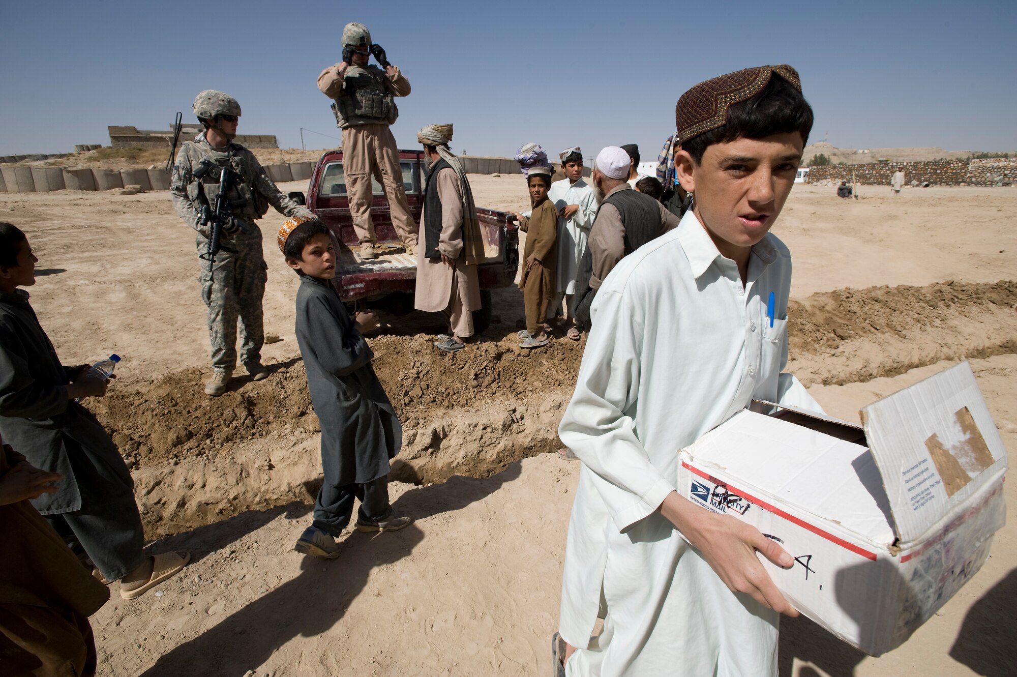 QALAT, Afghanistan – An Afghan child carries a box of school delivered to his school by the Zabul Provincial Reconstruction Team on behalf of the Westfield Community School in Algonquin, Ill. The donated school supplies ranged from pens and crayons to notebooks and glue.  (U.S. Air Force photo by Master Sgt. Keith Brown)
