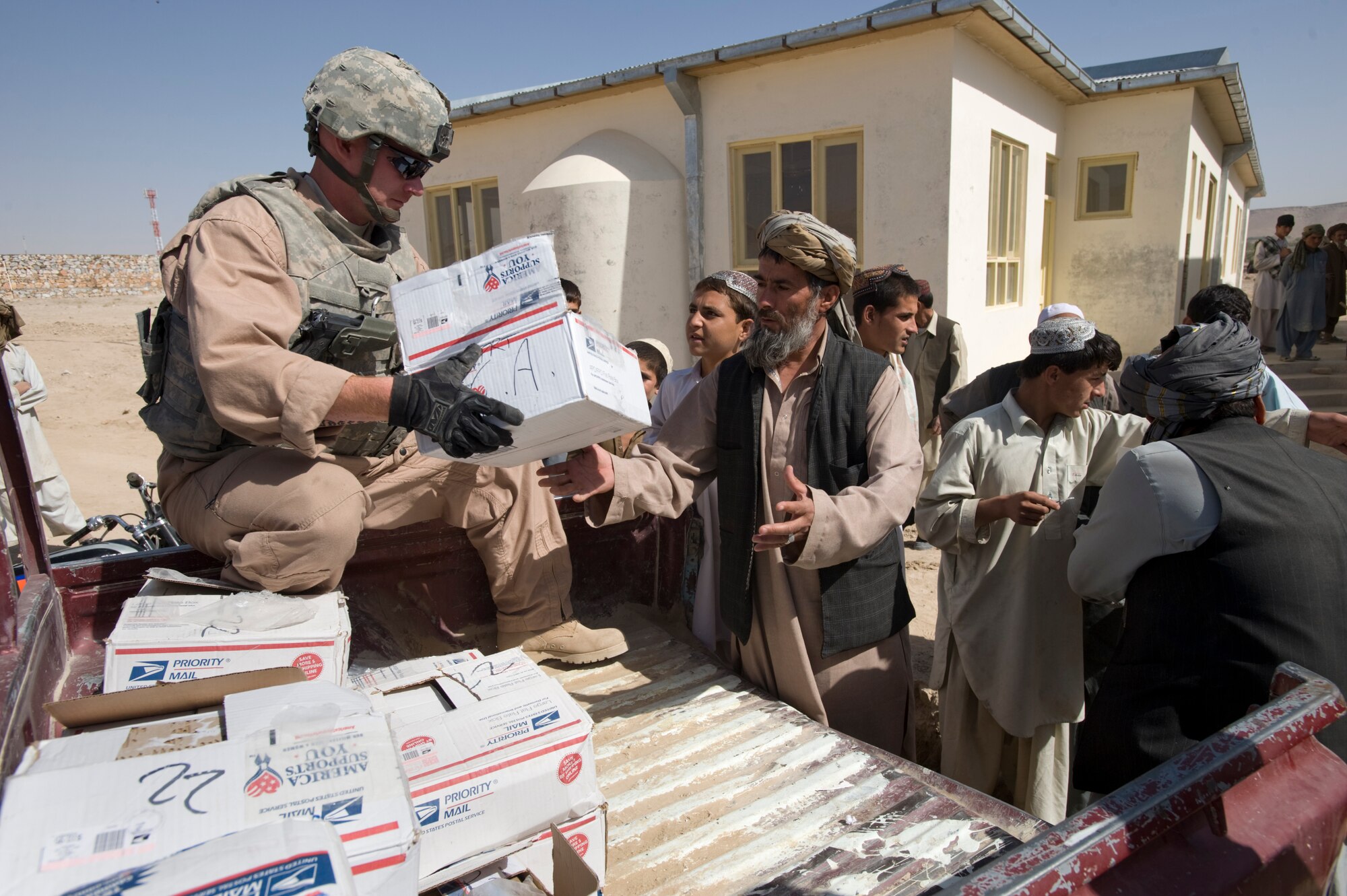 QALAT, Afghanistan – Army Sgt. Chris Stalder helps unload a donation of school supplies at an area school recently. The Zabul Provincial Reconstruction Team delivered the supplies on behalf of the Westfield Community School in Algonquin, Ill. Sergeant Stadler, a native of Willis, Texas, is deployed from the 451st Civil Affairs Battalion, Pasadena, Texas. (U.S. Air Force photo by Master Sgt. Keith Brown)