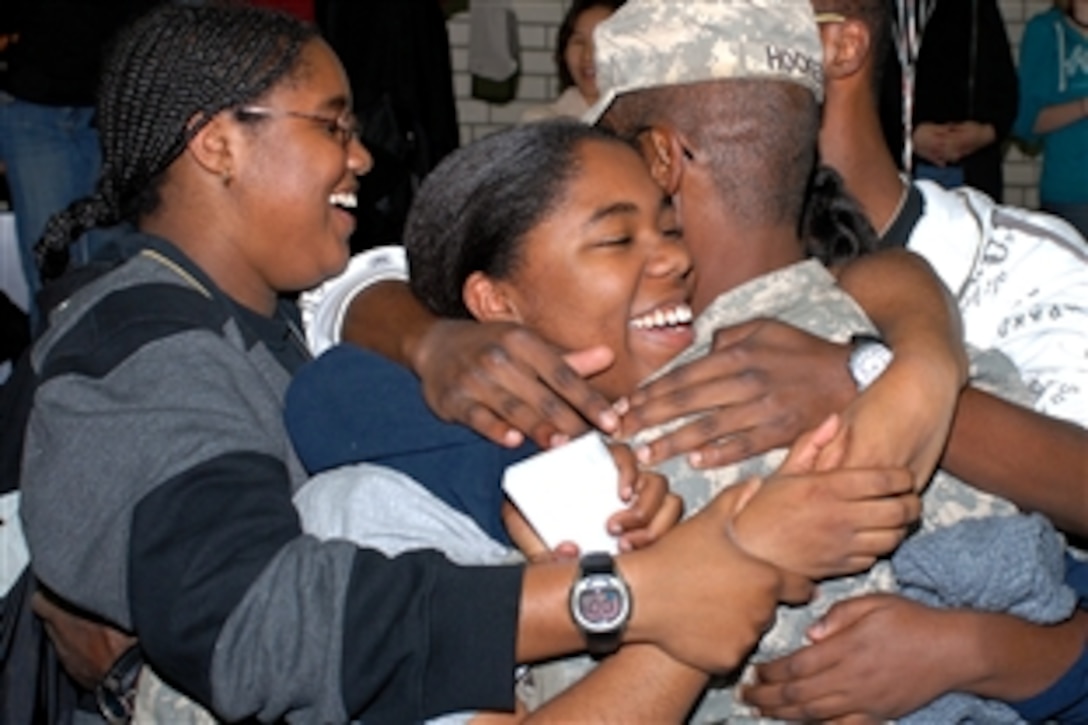 U.S. Army Sgt.1st Class Danny J. Hocker is embraced by his family during a welcome home ceremony in Vilseck, Germany, Oct. 23, 2008. Hocker, assigned to 2nd Stryker Cavalry Regiment, is returning to Germany after 15 months of supporting Operation Iraqi Freedom.