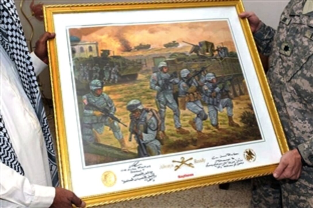 U.S. Army Lt. Col. Douglass Sims, right, assigned to the 2nd Stryker Cavalry Regiment, presents a painting depicting the members of his unit to Sheik Abu Ikhlaas, left, as a parting gift to commemorate the work the sheik and his unit have done together to improve security in Baquabah, Iraq, Oct. 24, 2008.