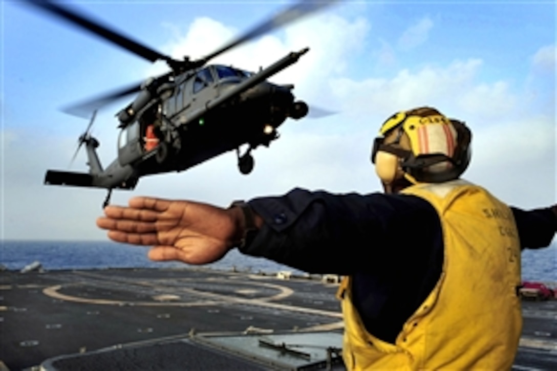 An HH-60G Pave Hawk helicopter from the Alaska Air National Guard 210th Rescue Squadron performs deck landing qualifications aboard the guided-missile cruiser USS Shiloh to prepare for Hong Kong Search and Rescue Exercise 2008, Oct. 26, 2008. The annual exercise involves units from the United States, Hong Kong and the People's Republic of China.