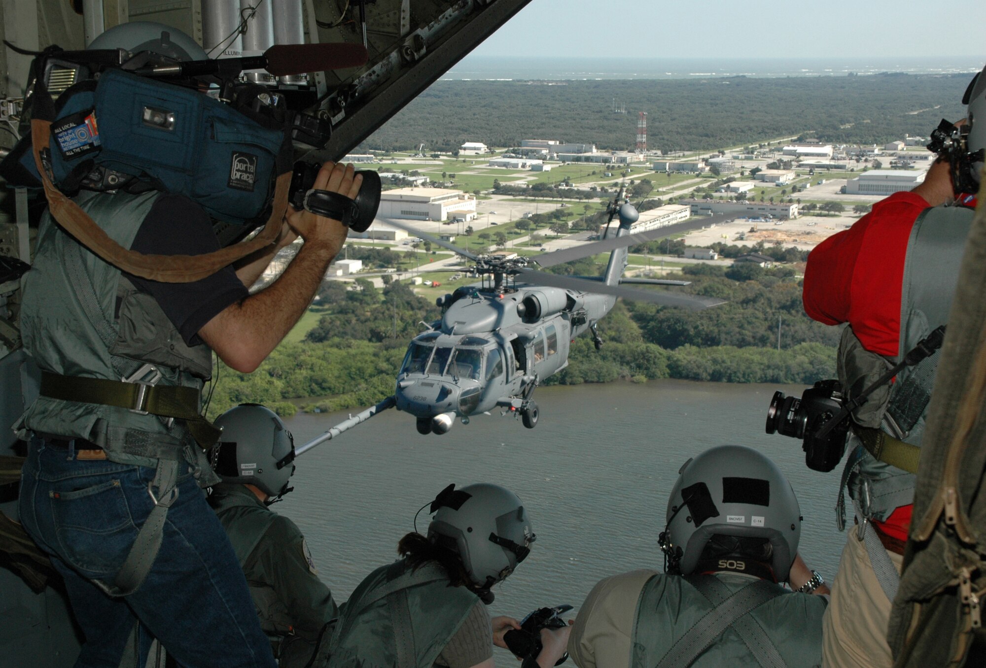 KENNEDY SPACE CENTER, Fla. - Central Floridal media personnel fly aboard an Air Force Reserve HC-130P/N Hercules refueling aircraft during the 2007 Kennedy Space Center Air and Space Expo.  The media film the C-130 tanker as it lowers hoses from its wings to refuel two HH-60G Pave Hawk helicopters as once.  The aircraft were part of the 920th Rescue Wing's astronaut recovery demonstration during the '07 show.  The 920th RW is preparing to perform again at the 2008 KSC Air and Space Expo scheduled Nov. 7-9.  (U.S. Air Force Photo/Staff Sgt. Heather Kelly)