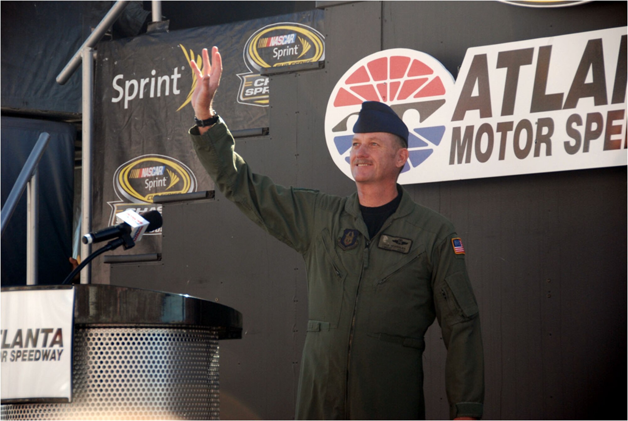 Chief Master Sgt. Lyle Spangler acknowledges cheering spectators at Atlanta Motor Speedway Oct. 26 after the track announcer read a message honoring the 711th Special Operations Squadron aircrew loadmaster's highly decorated, 35-year military service. (Courtesy Photo)