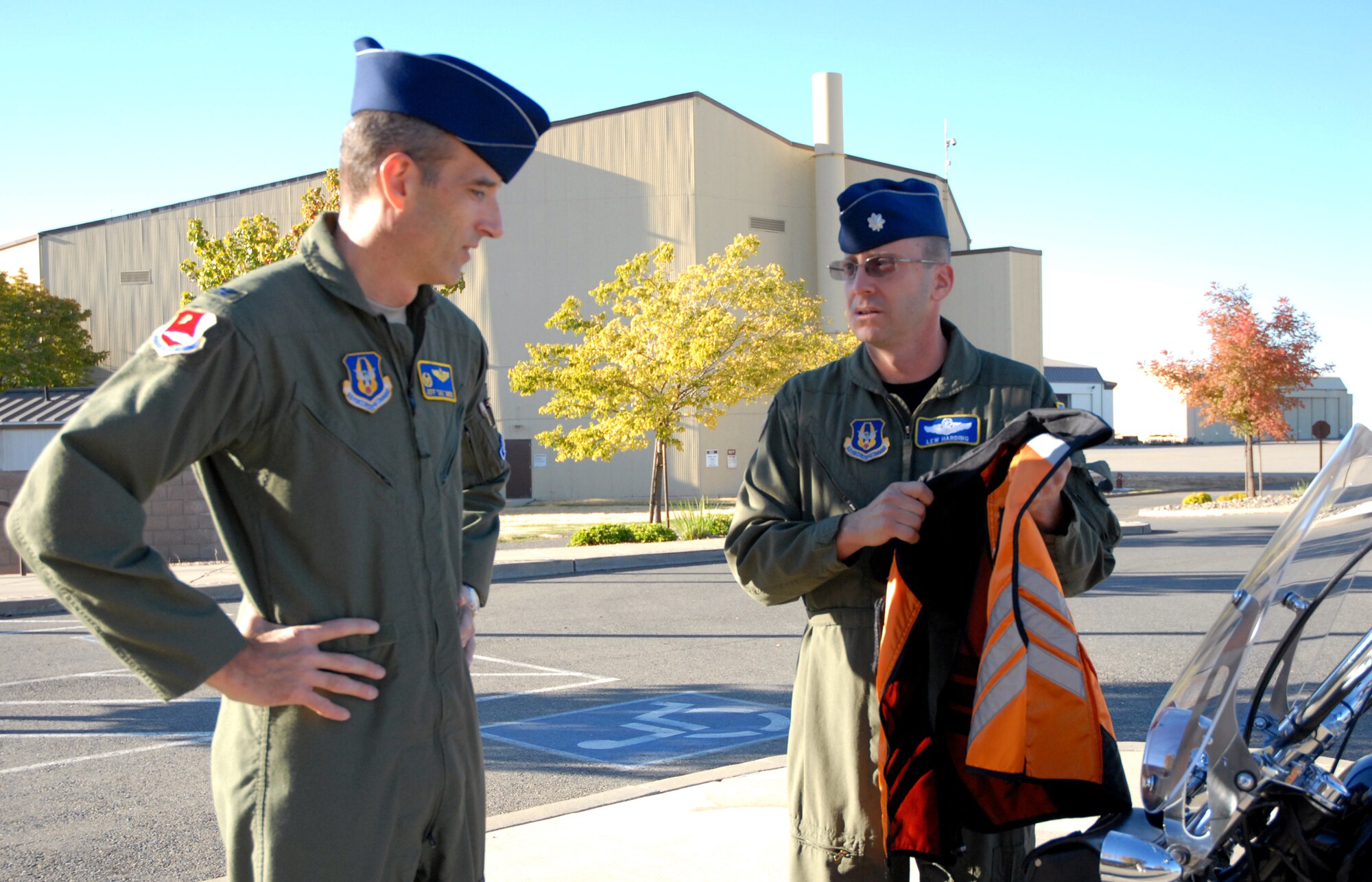 BEALE AIR FORCE BASE, Calif. -- Air Force Reservist Lt. Col. Lew Harding, 940th Air Refuleing Wing chief of safety, shows his motorcycle riders reflective vest to Wing Commander, Col. Jeff "Sal" Mineo, Oct. 16, 2008. This garment is only one of the requirements for motorcycle riders on military installations. Beginning Dec. 1, all Beale AFB riders are required to display the AF Form 15 decal on their motorcycles, in accordance with Air Combat Command Supplement to AF Instruction 91-207. The decal signifies that the rider has completed a required motorcycle safety course. (U.S. Air Force photo/MSgt. Ellen L. Hatfield)     