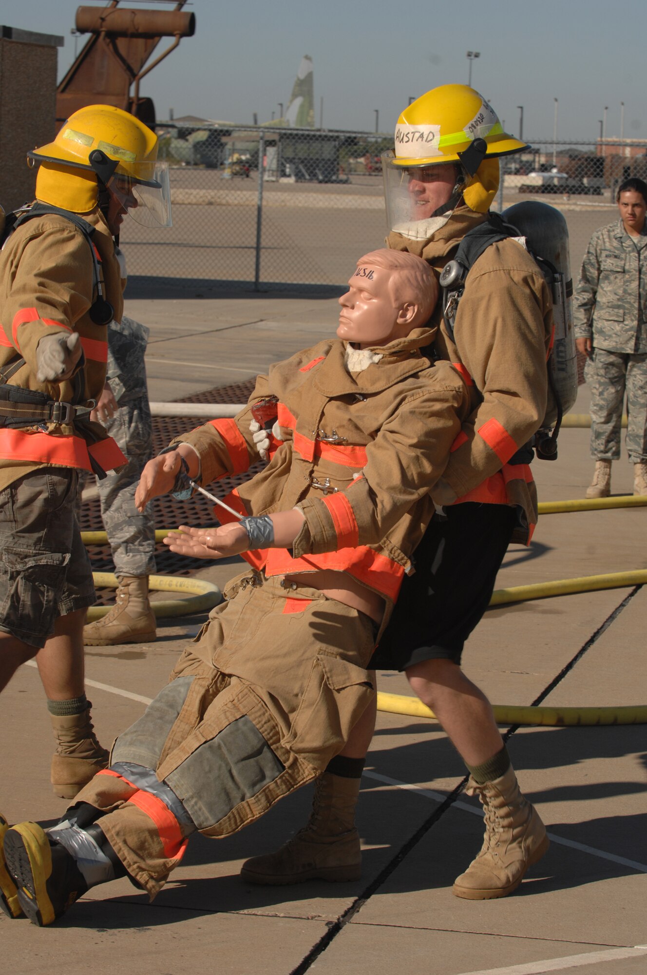 Rookie firefighters haul 45-pound ropes up the five-story tower while their opponents carry similar weights up the stairs behind them during the 2008 Rookie Firefighter Challenge at Goodfellow Air Force Base Oct. 25. (U.S. Air Force photo by Tech. Sgt. John Barton)
