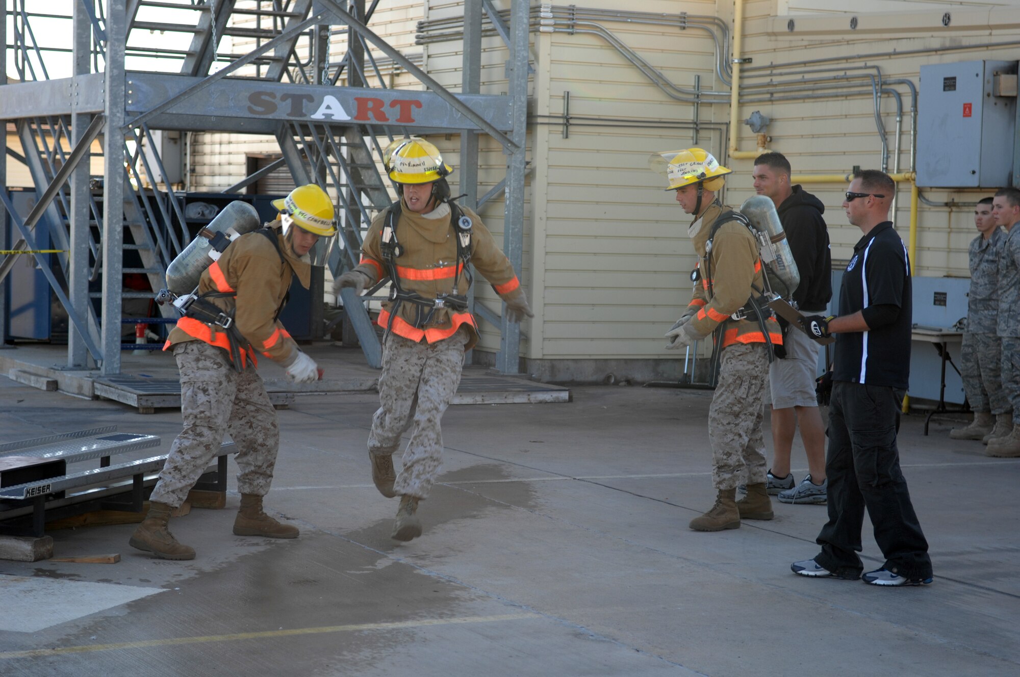 Marine Corps Pfcs. Joseph Campbell, Richard Kimmell and Aaron Ellich, technical training students at Goodfellow Air Force Base, compete in the 2008 Rookie Firefighter Challenge, Oct. 25. (U.S. Air Force photo by Tech. Sgt. John Barton)
