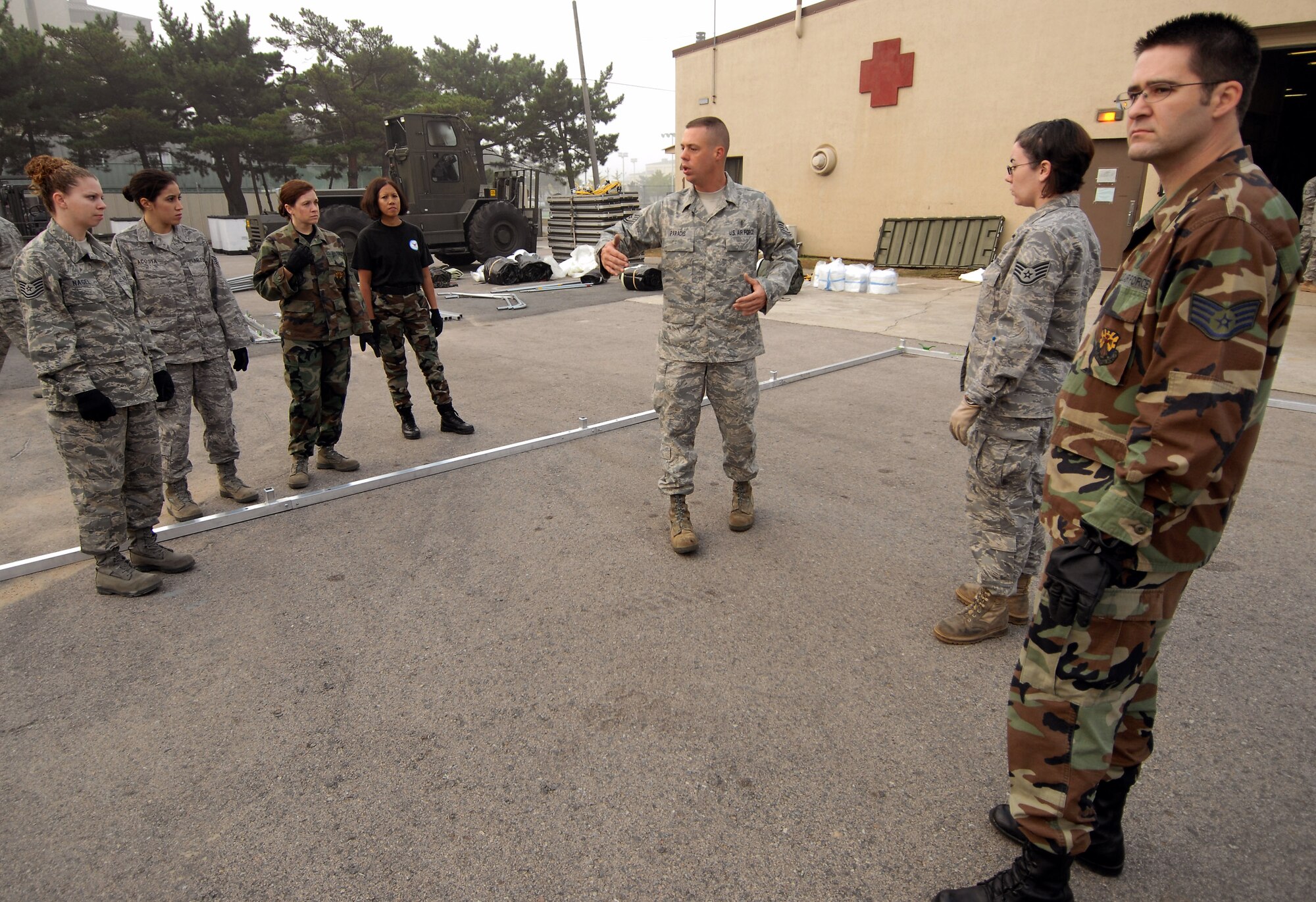 Tech. Sgt. Marc Paradis instructs Reserve Airman on constructing a medical staging facility Oct. 21 at Kunsan Air Base, South Korea. The reservists are from from Luke Air Force Base, Ariz., and Westover Air Reserve Base, Mass. Sergeant Paradis is assigned to the 36th Medical Support Squadron from Andersen Air Base, Guam. (U.S. Air Force photo/Senior Airman Gustavo Gonzalez) 
