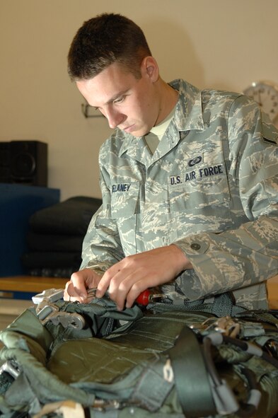 Airman Justin Delaney, 563rd Operations Support Squadron aircrew flight equipment, performs an inspection on a parachute to ensure serviceability here, October 30. (U.S. Air Force photo/Senior Airman Noah R. Johnson)