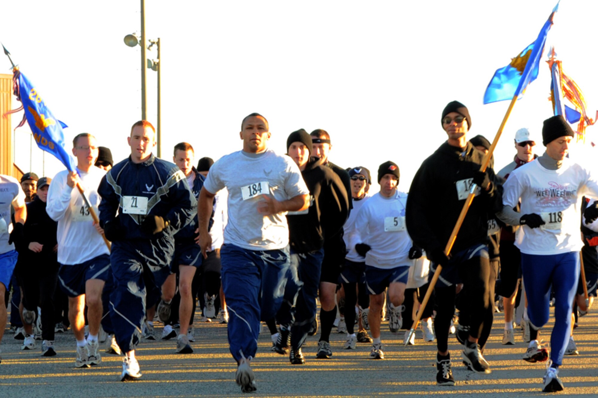 LANGLEY AIR FORCE BASE, Va.-- Airmen race across the starting line at the first sergeants' fun run here Oct 31. The fun run raised donations of food and money for Operation Warm Heart. Operation Warm Heart is a Langley First Sergeants Association community outreach program designed to support Airmen during the holiday season. The First Sergeants raised approximately $950 and more than 400 canned goods. (U.S. Air Force photo/Airman 1st Class Jonathan Koob)
