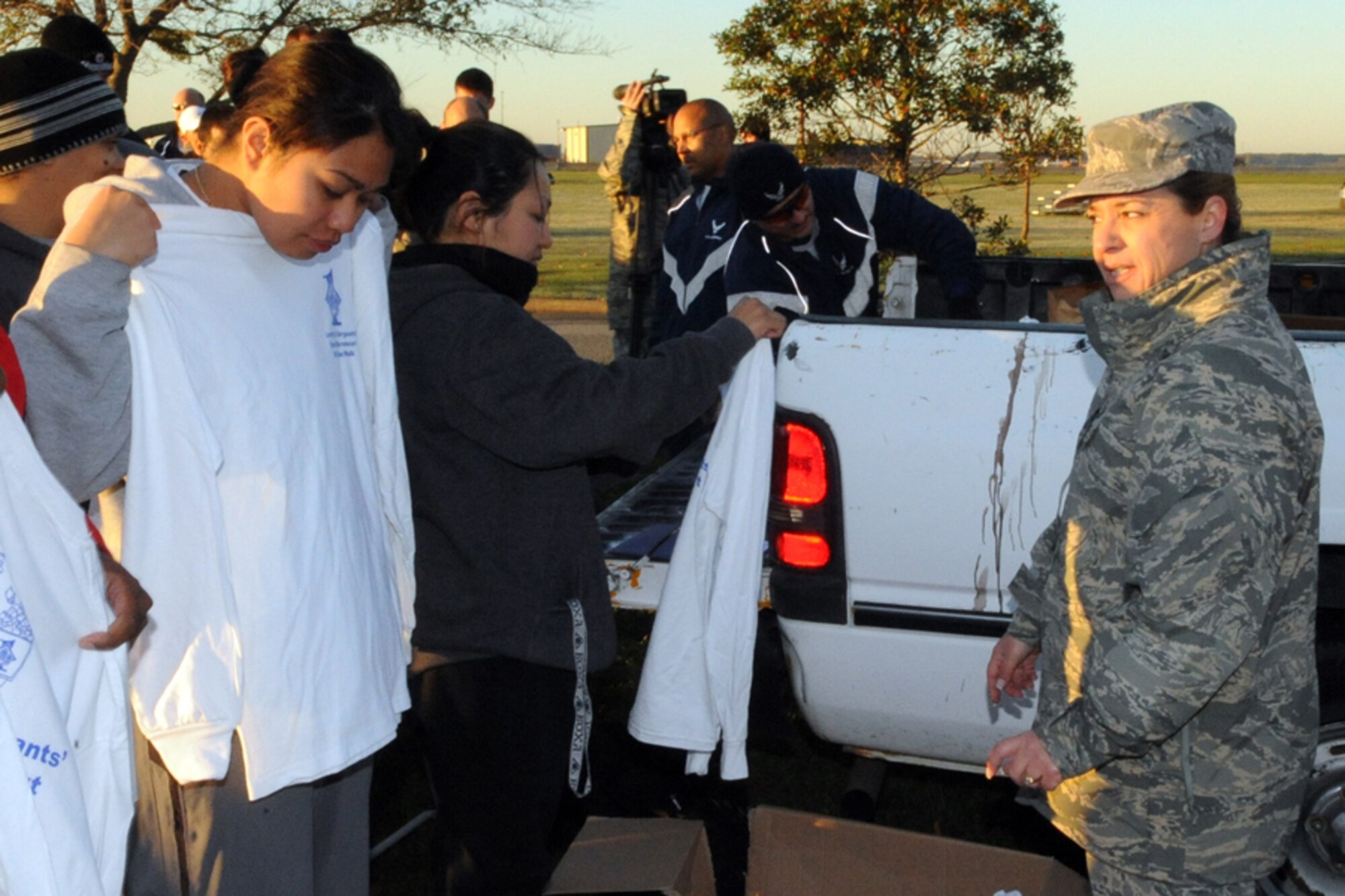 LANGLEY AIR FORCE BASE, Va.-- Master Sgt. Pamela Hadsell, 1st Civil Engineer Squadron first sergeant, gives a complimentary shirt to Staff Sgt. Geraldine Parker, 10th Intelligence Squadron, during the first sergeants' fun run here Oct 31. The fun run raised donations of food and money for Operation Warm Heart. Operation Warm Heart is a Langley First Sergeants Association community outreach program designed to support Airmen during the holiday season. The First Sergeants raised approximately $950 and more than 400 canned goods. (U.S. Air Force photo/Airman 1st Class Jonathan Koob)