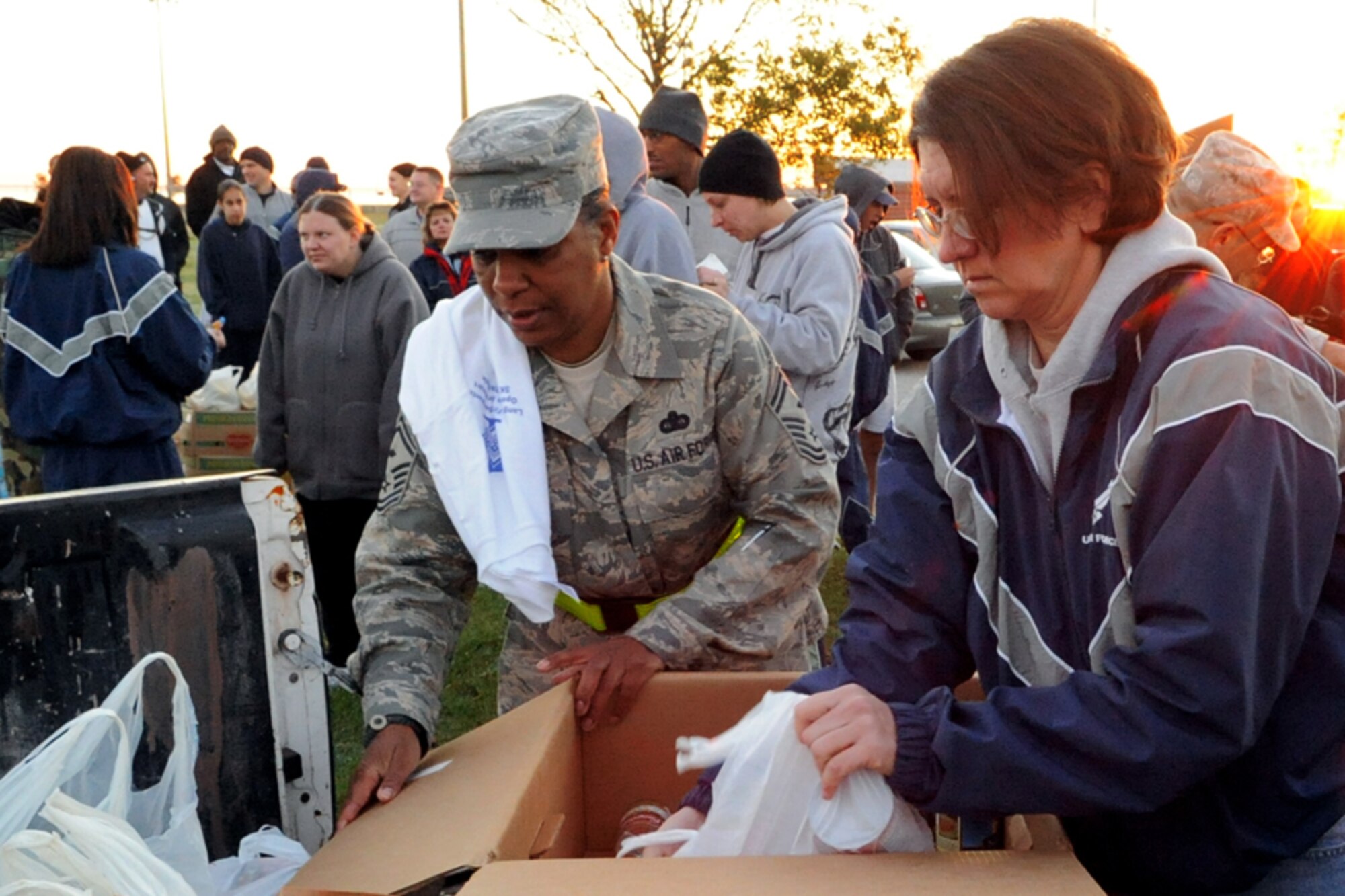 LANGLEY AIR FORCE BASE, Va.-- Senior Master Sgt. Shelin Frey, 1st Equipment Maintenance Squadron first sergeant, and Master Sgt. Cynthia Newton, 1st Maintenance Operations Squadron first sergeant, gather canned goods donated by participants in the first sergeants' fun run here Oct 31. The fun run raised donations of food and money for Operation Warm Heart. Operation Warm Heart is a Langley First Sergeants Association community outreach program designed to support Airmen during the holiday season. The First Sergeants raised approximately $950 and more than 400 canned goods. (U.S. Air Force photo/Airman 1st Class Jonathan Koob)