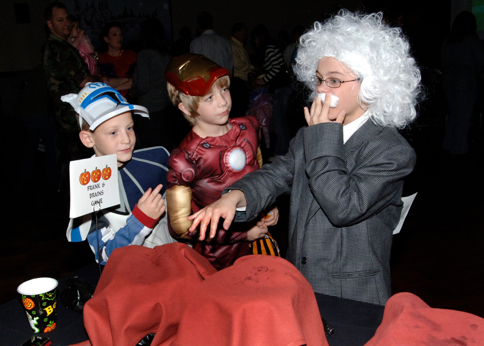 FAIRCHILD AIR FORCE BASE, Wash. – Children take turns playing “Frank and Brains,” guessing what’s inside each covered cauldron at the FAN Club Boo Bash Oct. 29. The night's events included a costume contest, cash prizes, pumpkin decorating, caramel apples and other party activities. FAN Club members and families enjoyed the event for free. (U.S. Air Force photo / Airman 1st Class Melissa L. Barnett)