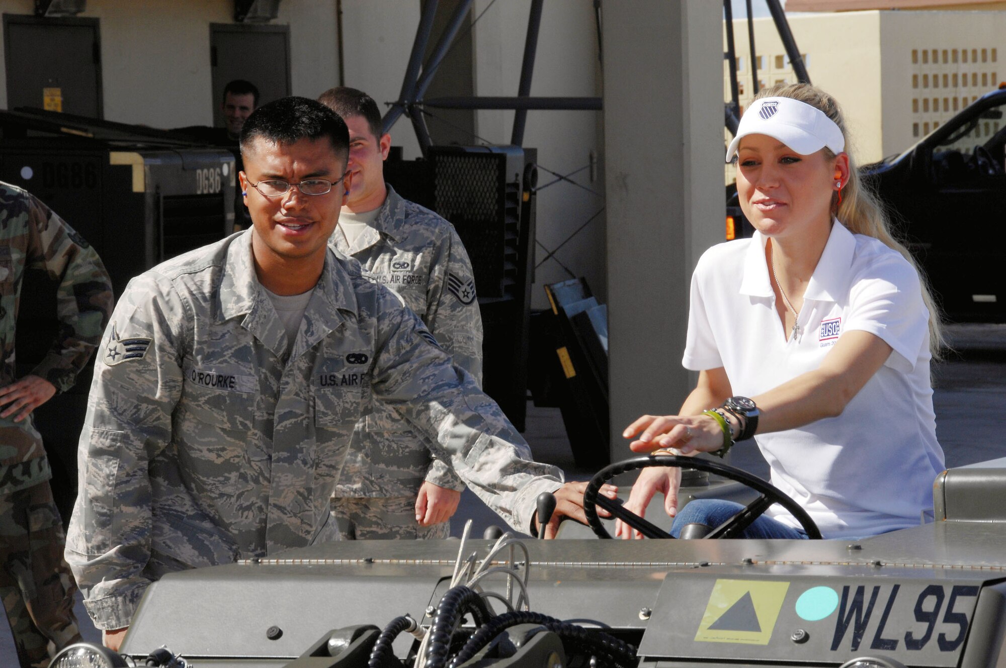 Senior Airman Michael O'Rourke shows Anna Kournikova how to operate a bomblifter Oct. 29 at Andersen Air Force Base, Guam. Airman O'Rourke is assigned to the 36th Maintenance Squadron. (U.S. Air Force photo/Airman 1st Class Nichelle Griffiths) 
