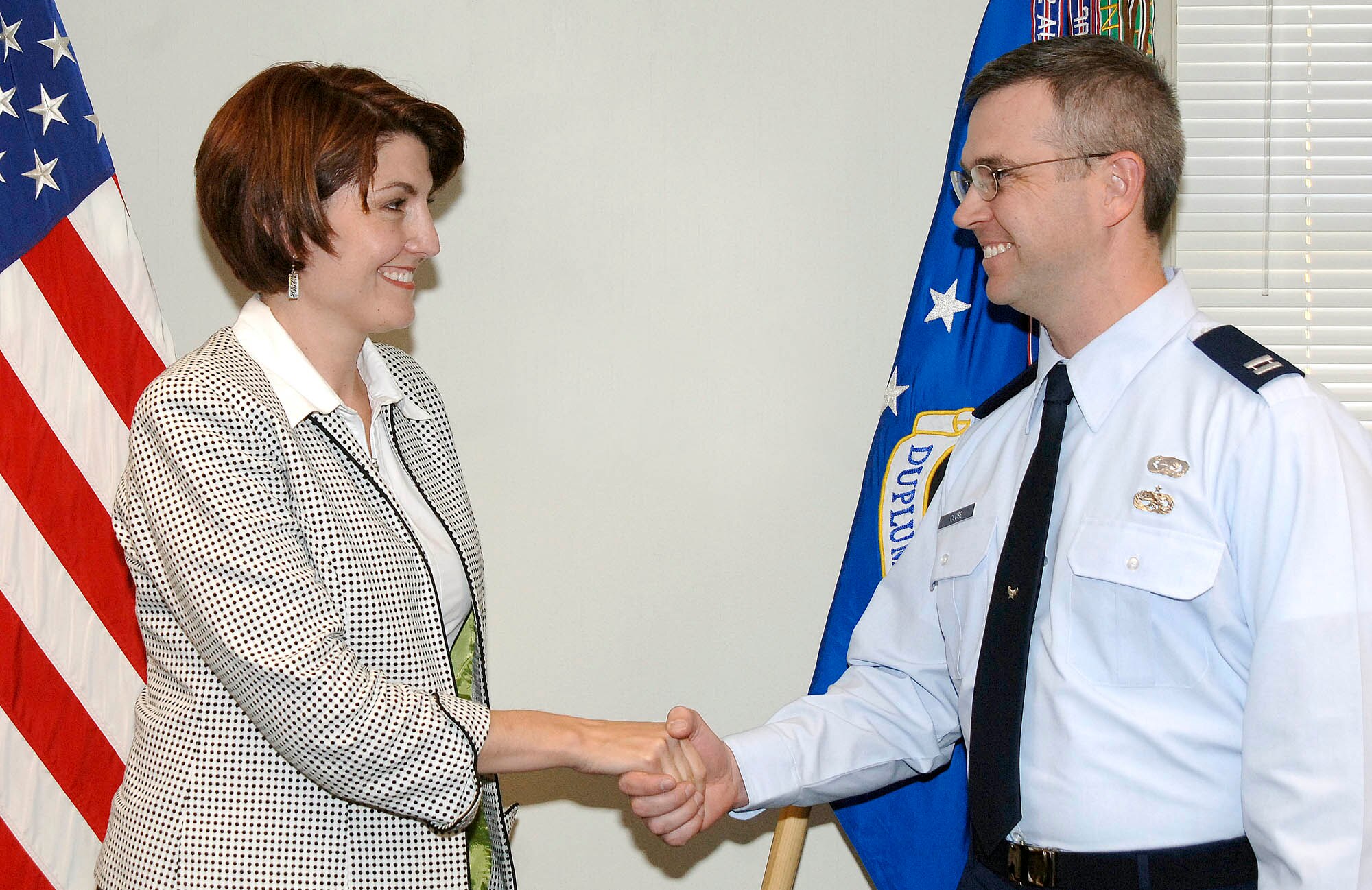 FAIRCHILD AIR FORCE BASE, Wash. – Representative Cathy McMorris-Rodgers presents Capt. Carl Close, 92nd Logistic Readiness Squadron officer, with her official coin in the 92nd Air Refueling Wing commander’s office Oct. 27. Both Col. Robert Thomas, 92nd ARW commander, and the congresswoman acknowledged the captain’s accomplishments while serving in southern Afghanistan April 2007 – April 2008.  The coin represents a token of gratitude for Captain Close’s service and dedication while fighting the Global War on Terrorism. (U.S. Air Force photo / Staff Sgt. JT May III) 